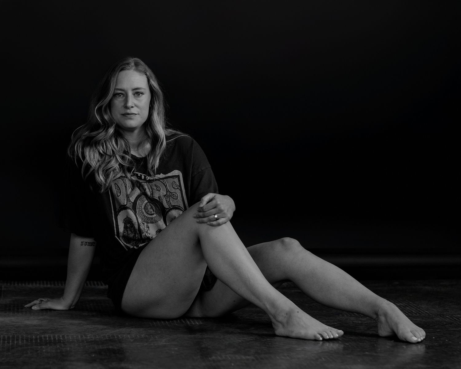 Relaxed floor poses captured in moody black and white photography.