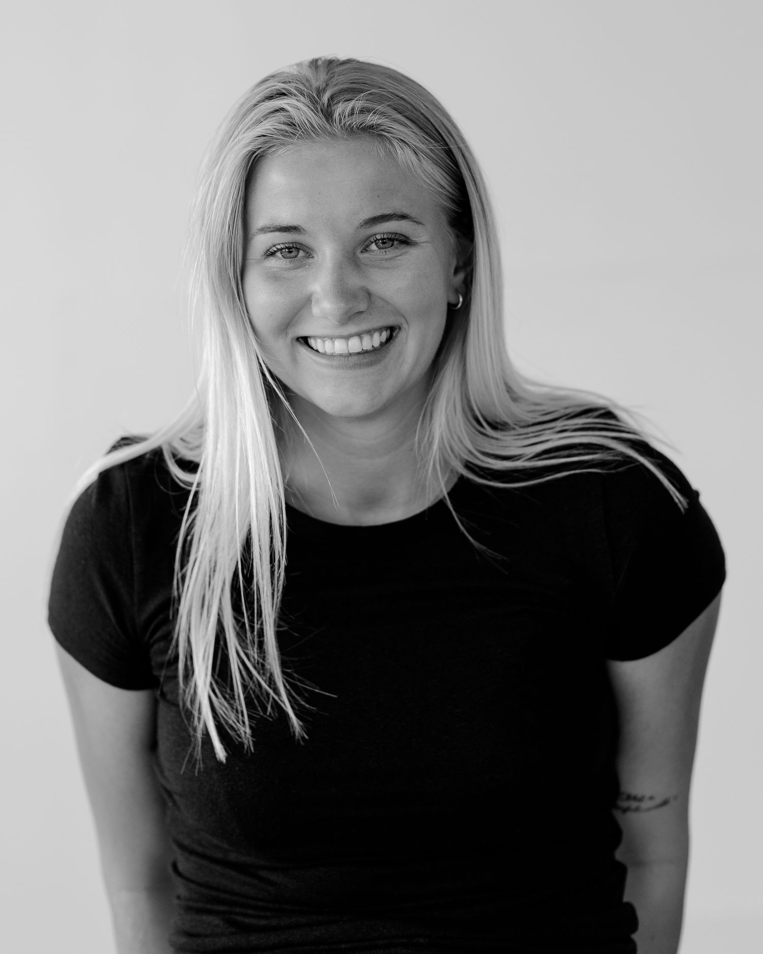 Collection of black and white portraits showing natural smiles and poses.