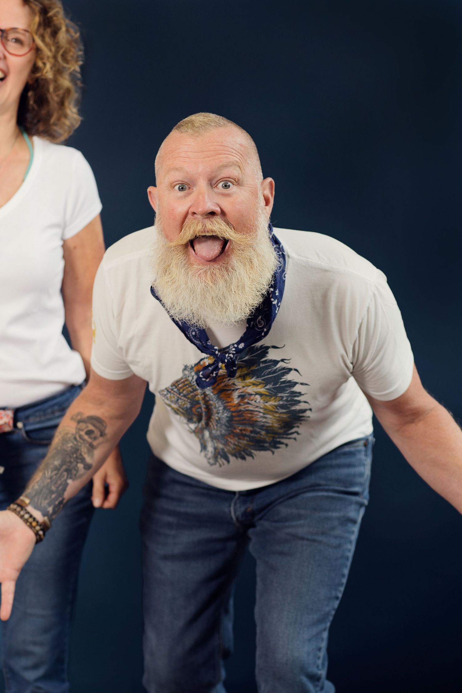 Against a dark background, a person in a white t-shirt and jeans makes playful poses in a sequential photo series.