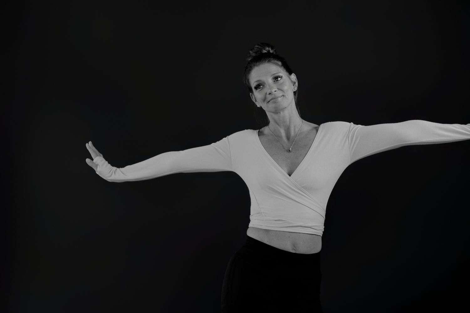 Graceful dance movements captured in black and white with extended arms.