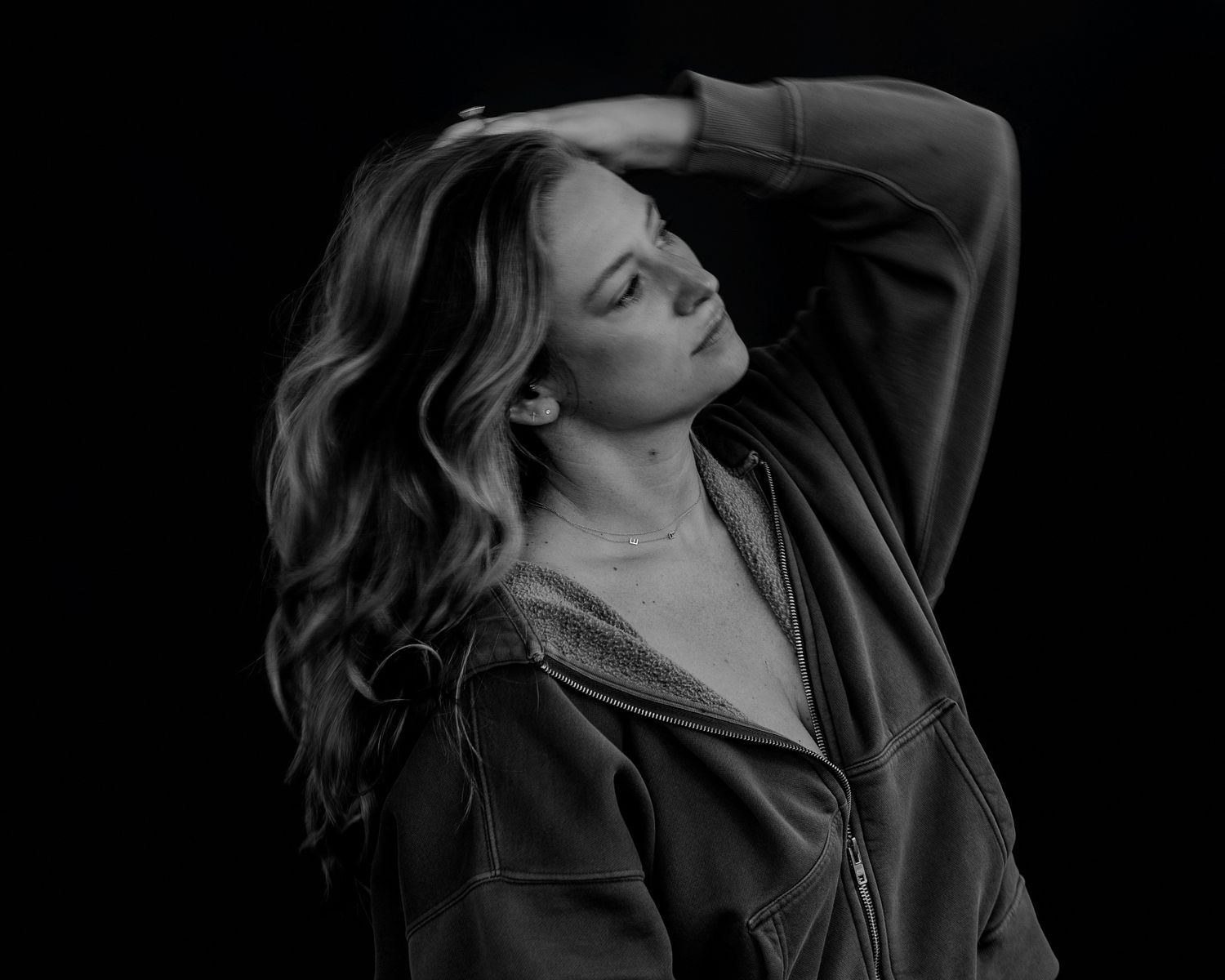 Dramatic portrait series showing movement against deep black background.