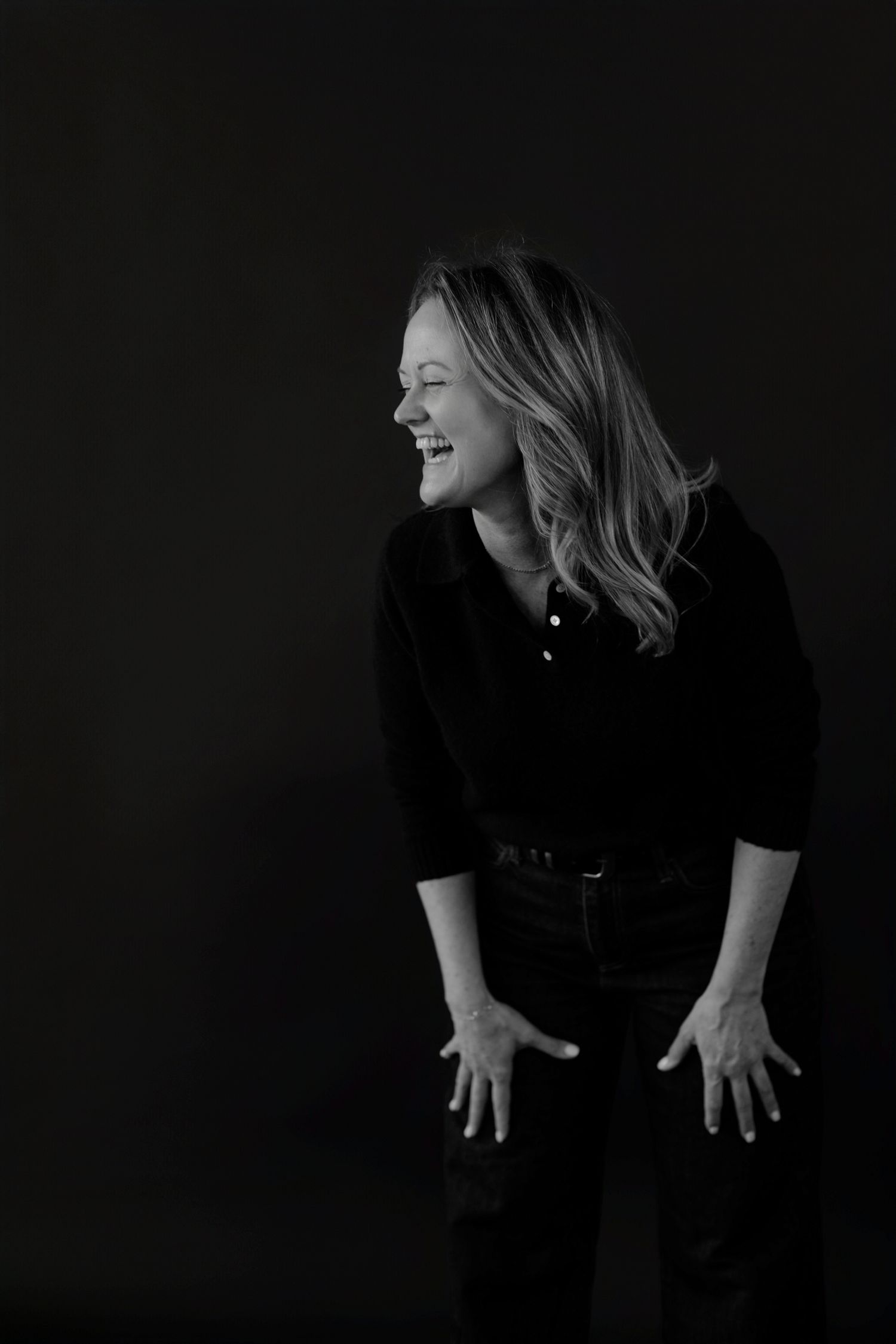 Artistic black and white portrait series showing expressive movement and joy against dark background.