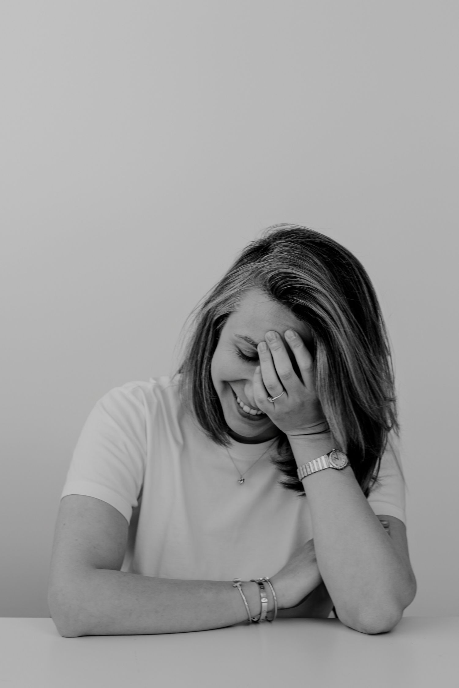 Person in white shirt showing signs of frustration or exhaustion in monochrome series.