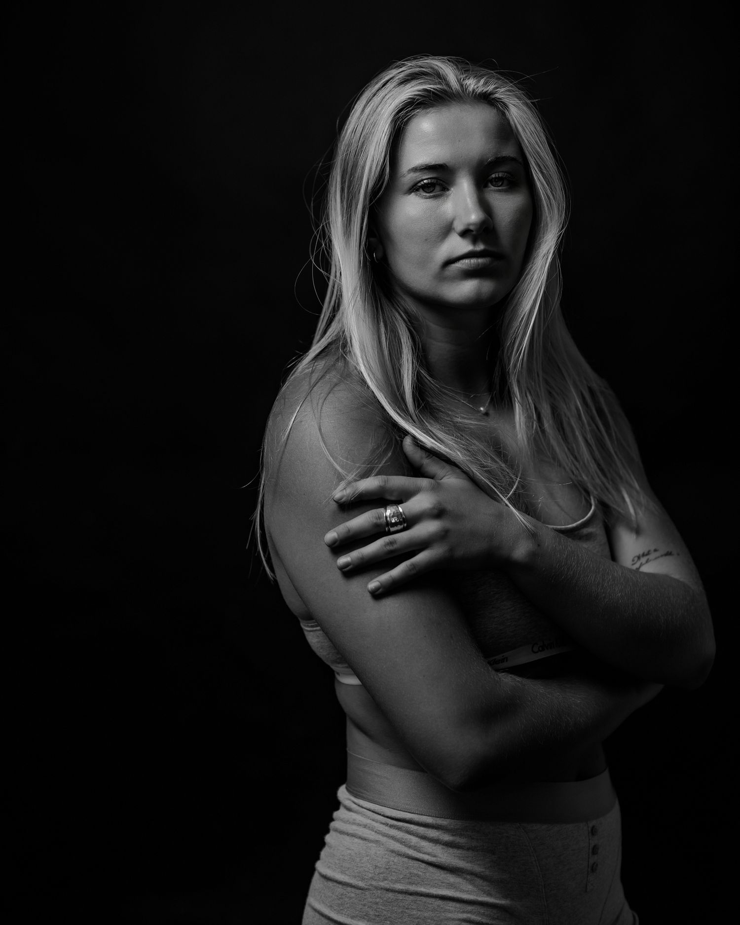 Dramatic low-key portraits with expressive body language against a dark background.