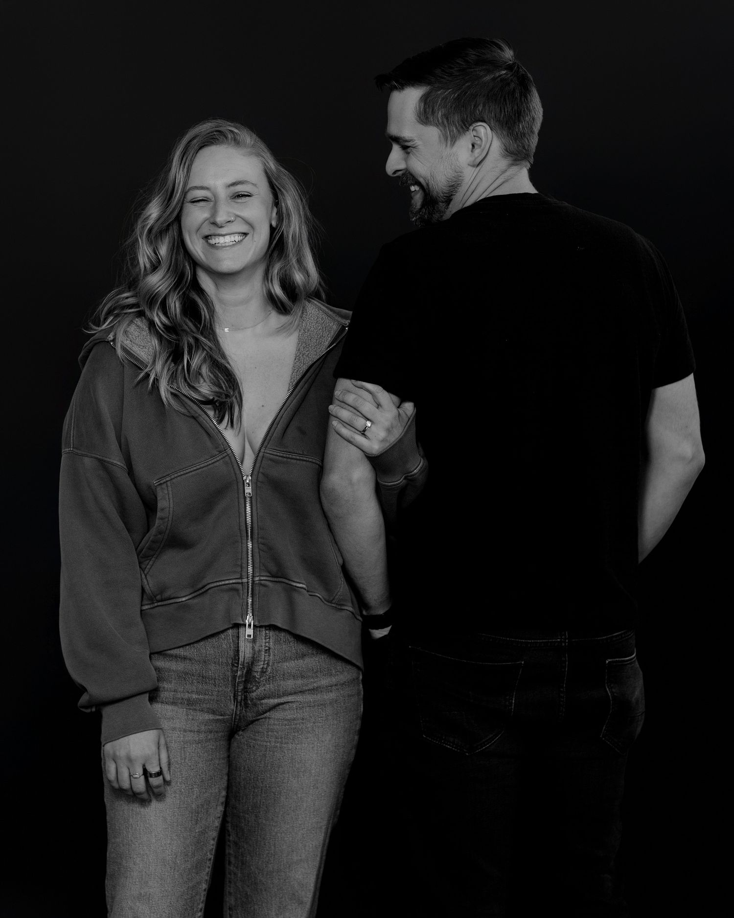 Moody black and white portraits capturing genuine moments between two people.