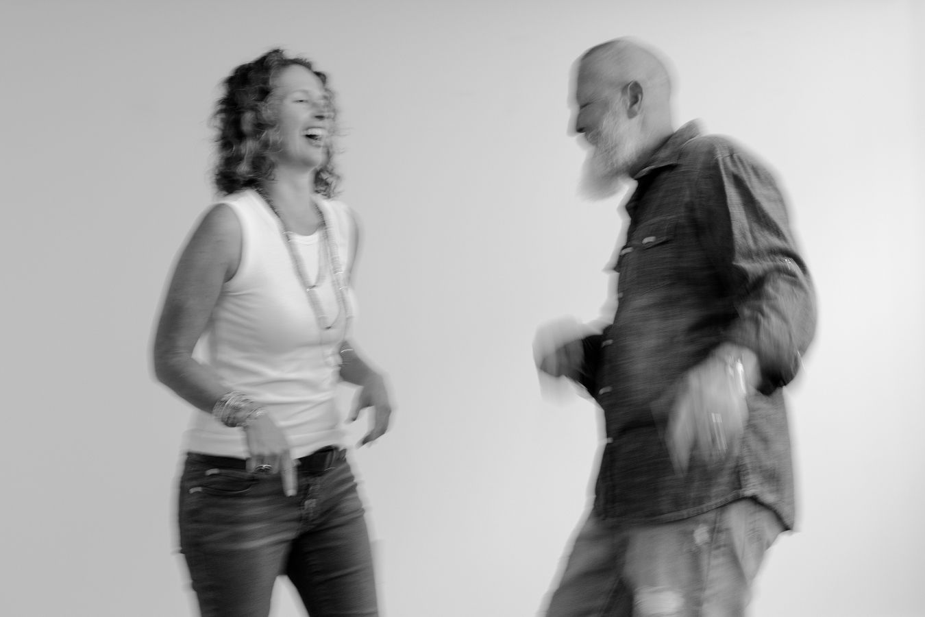 Dynamic black and white photo series capturing two people dancing and interacting playfully.