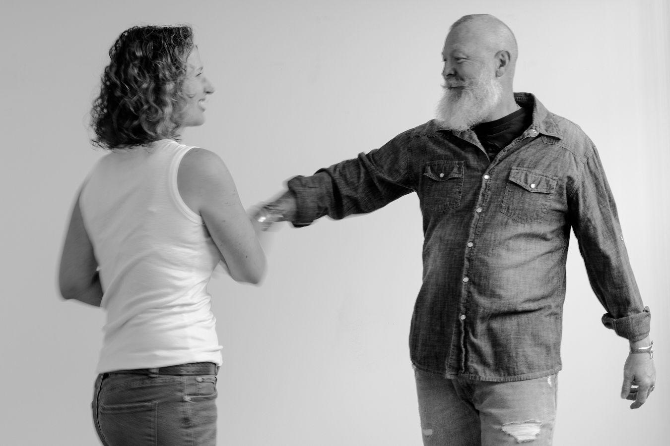 Black and white photo series depicting lively dance interaction between two performers.