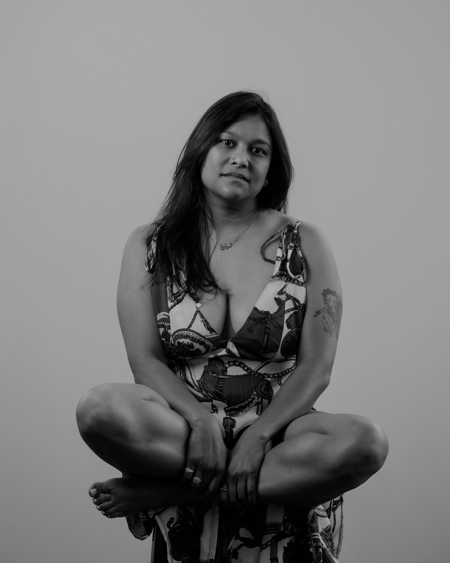 Artistic black and white portrait series showing dynamic poses in floral dress.
