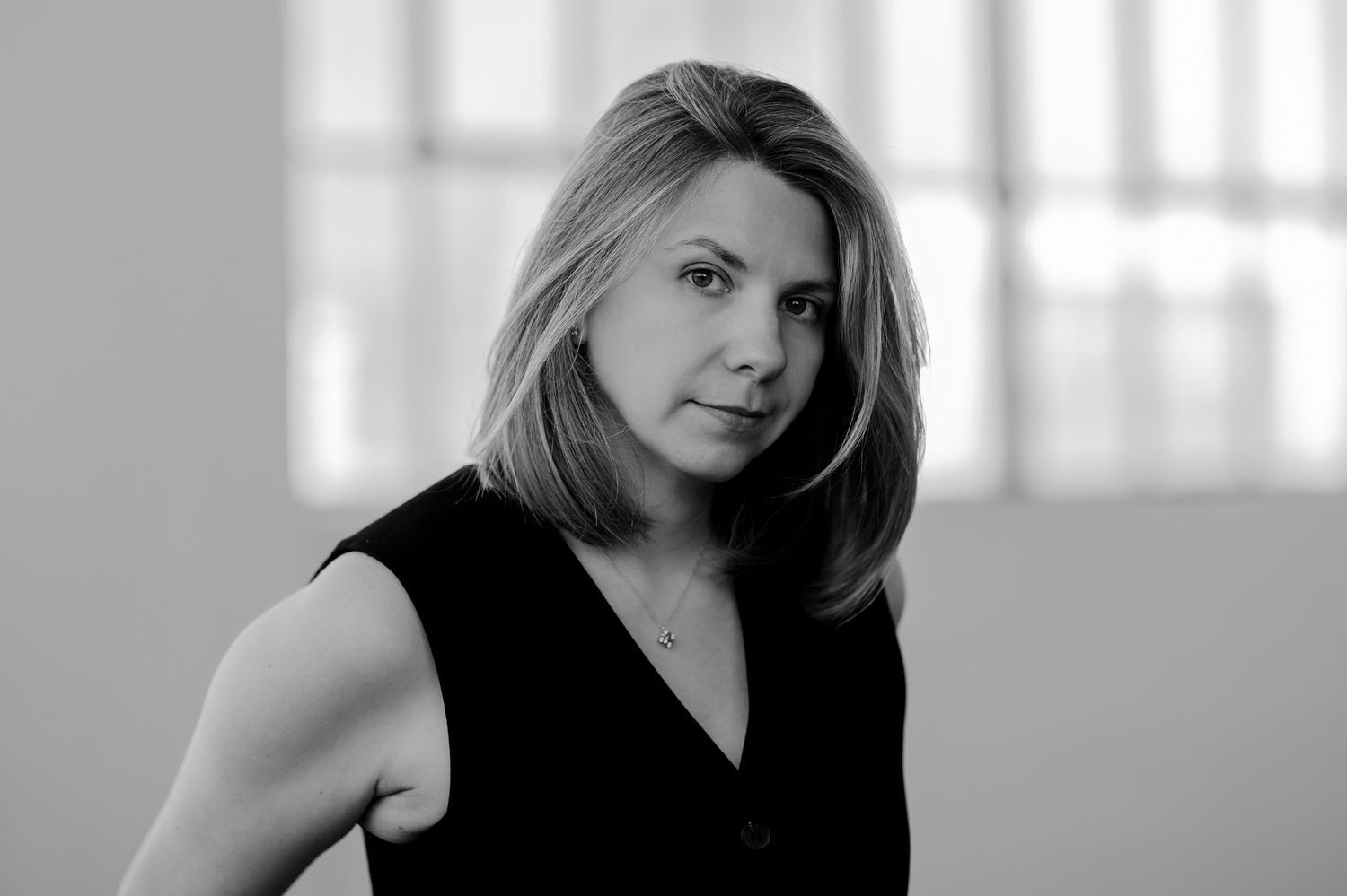 High key portrait series with person in black sleeveless top against bright window light.