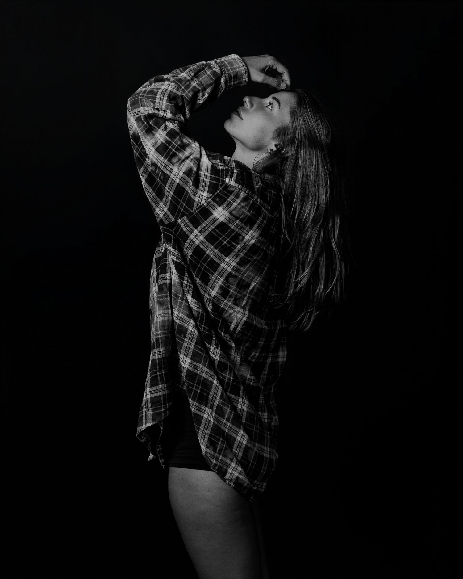 Dramatic black and white photography series with plaid shirt and dark shadows.