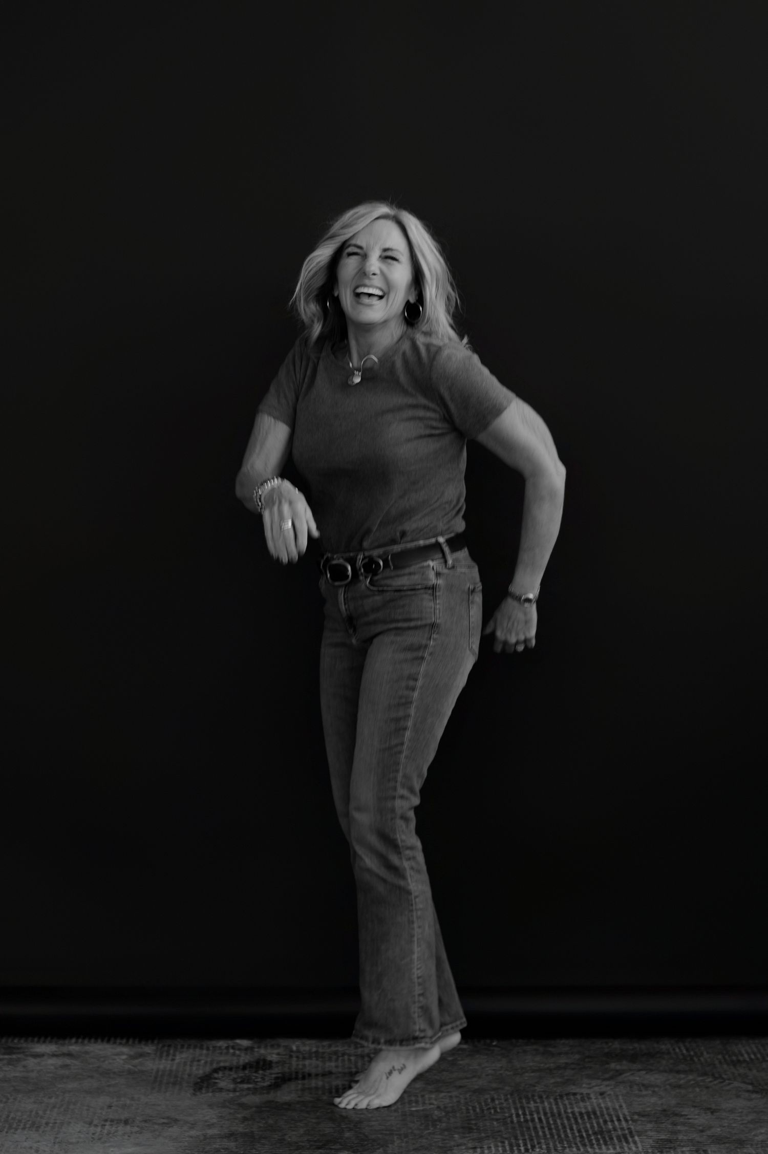 Dynamic black and white photo showing movement and joy against dark background.
