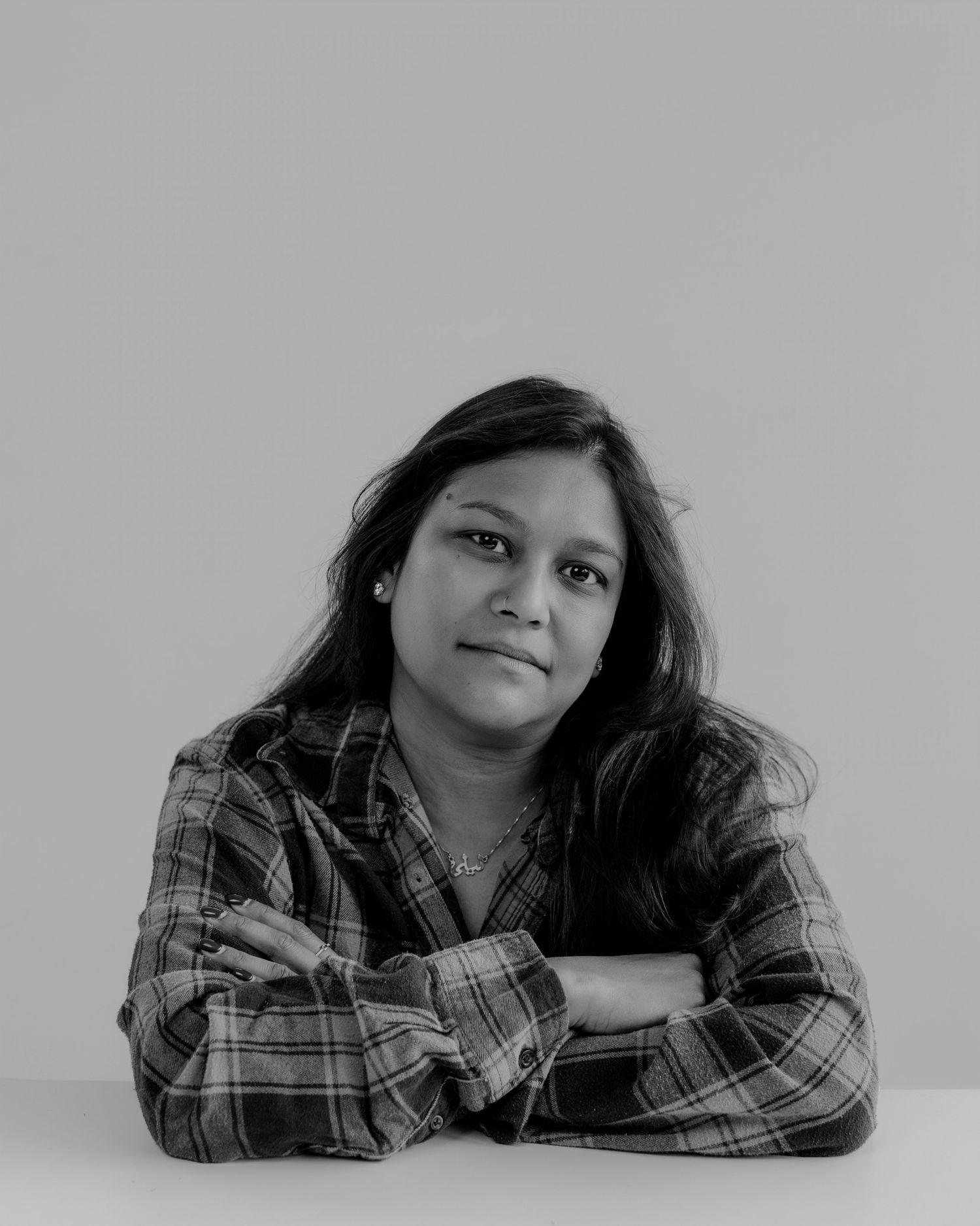 Figure in plaid shirt resting on surface with various expressions in monochrome.