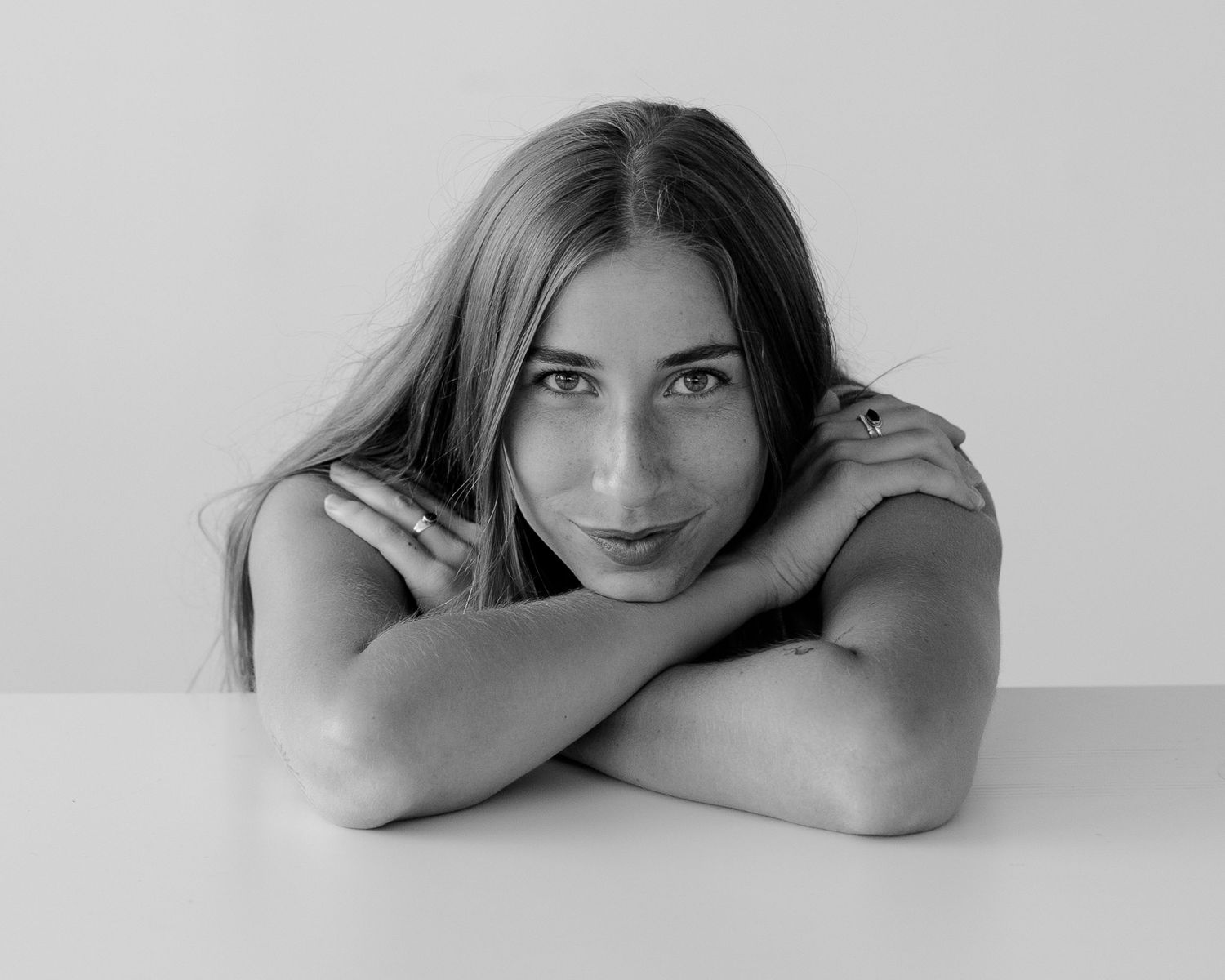 Minimalist black and white portrait series showing artistic poses on a light background.