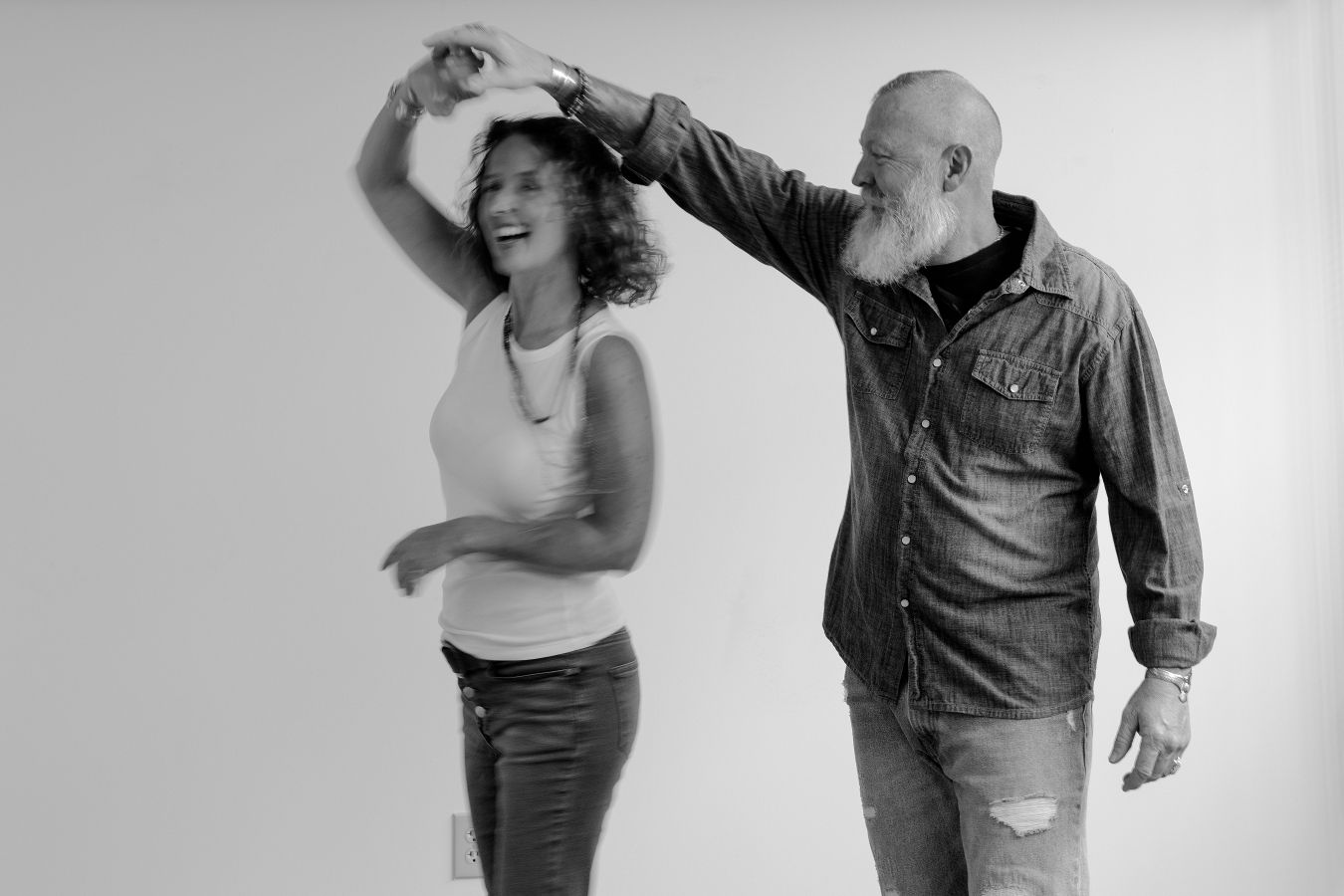 Energetic dance sequence showing two people performing expressive movements in a studio setting.