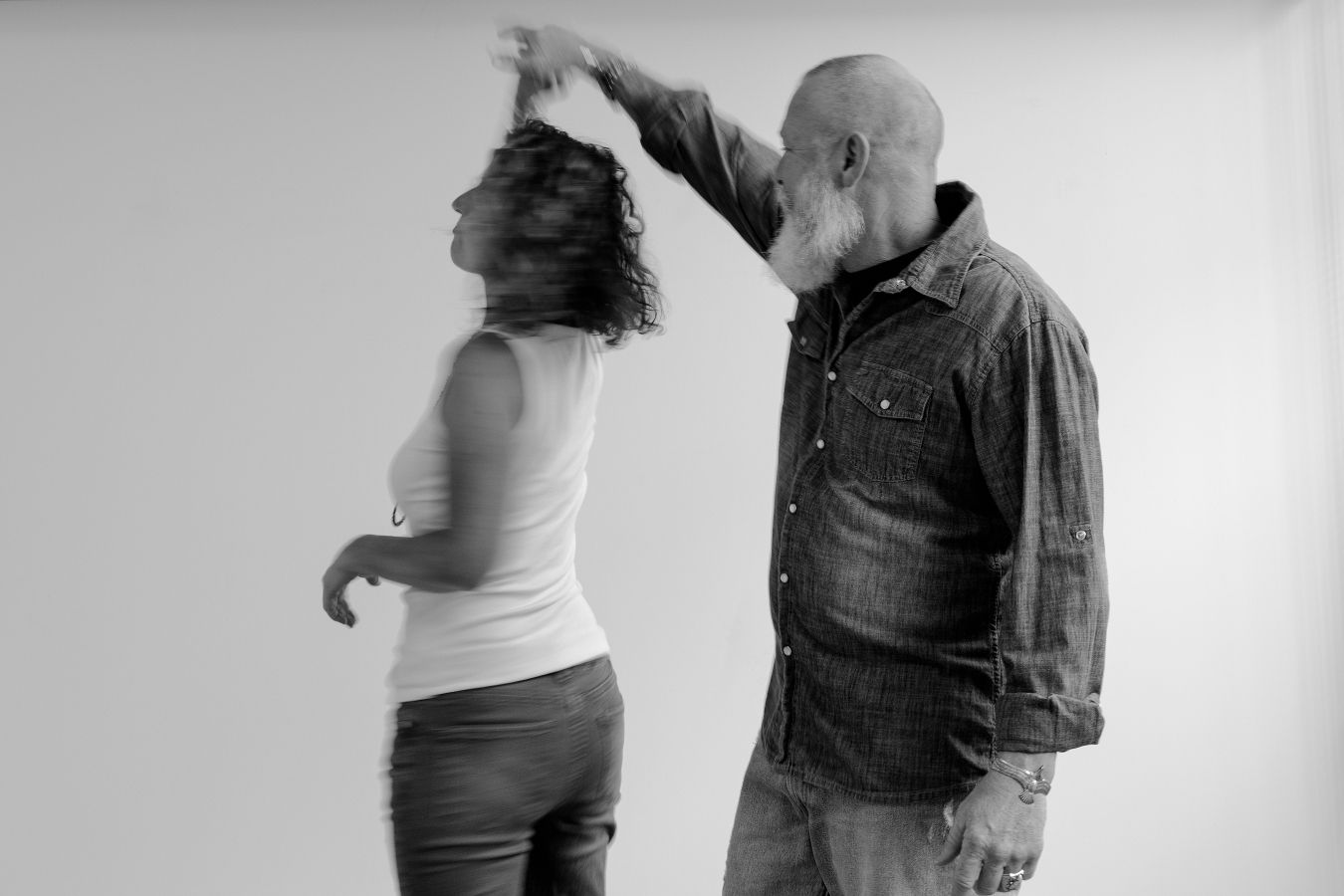 A series of dance movements shown in black and white photography with two dancers in motion.