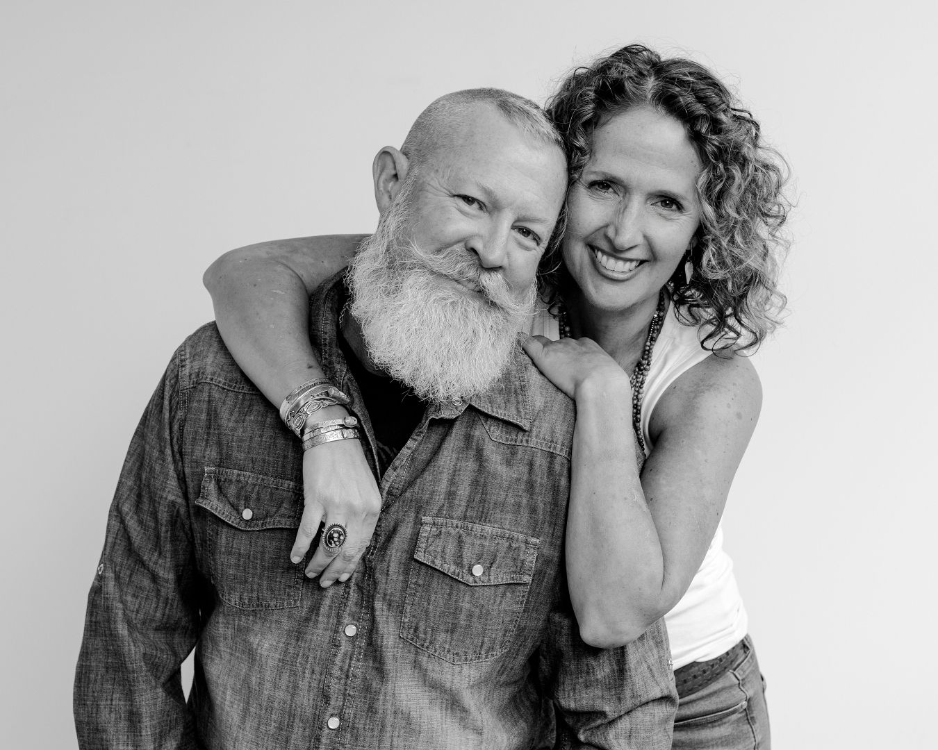 Black and white portrait series showing couple's affectionate poses and natural chemistry.