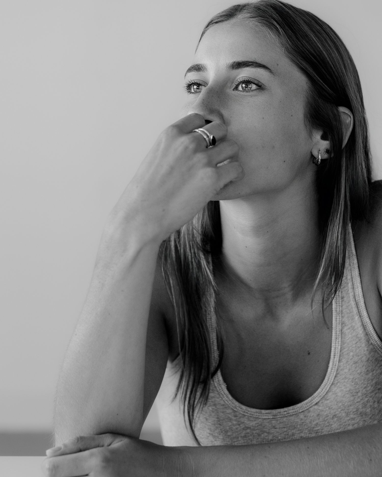 Woman holding her nose in a sequence of black and white portrait shots.