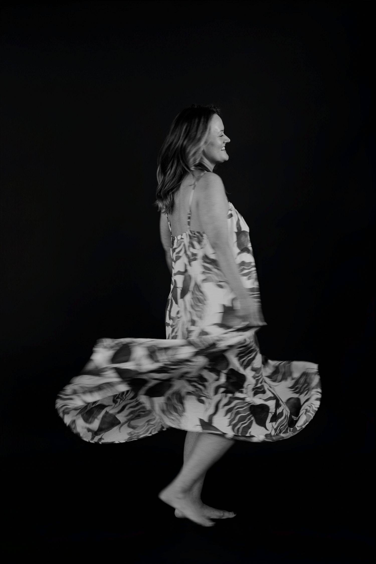 Abstract motion study of twirling dress creating flowing patterns in monochrome.