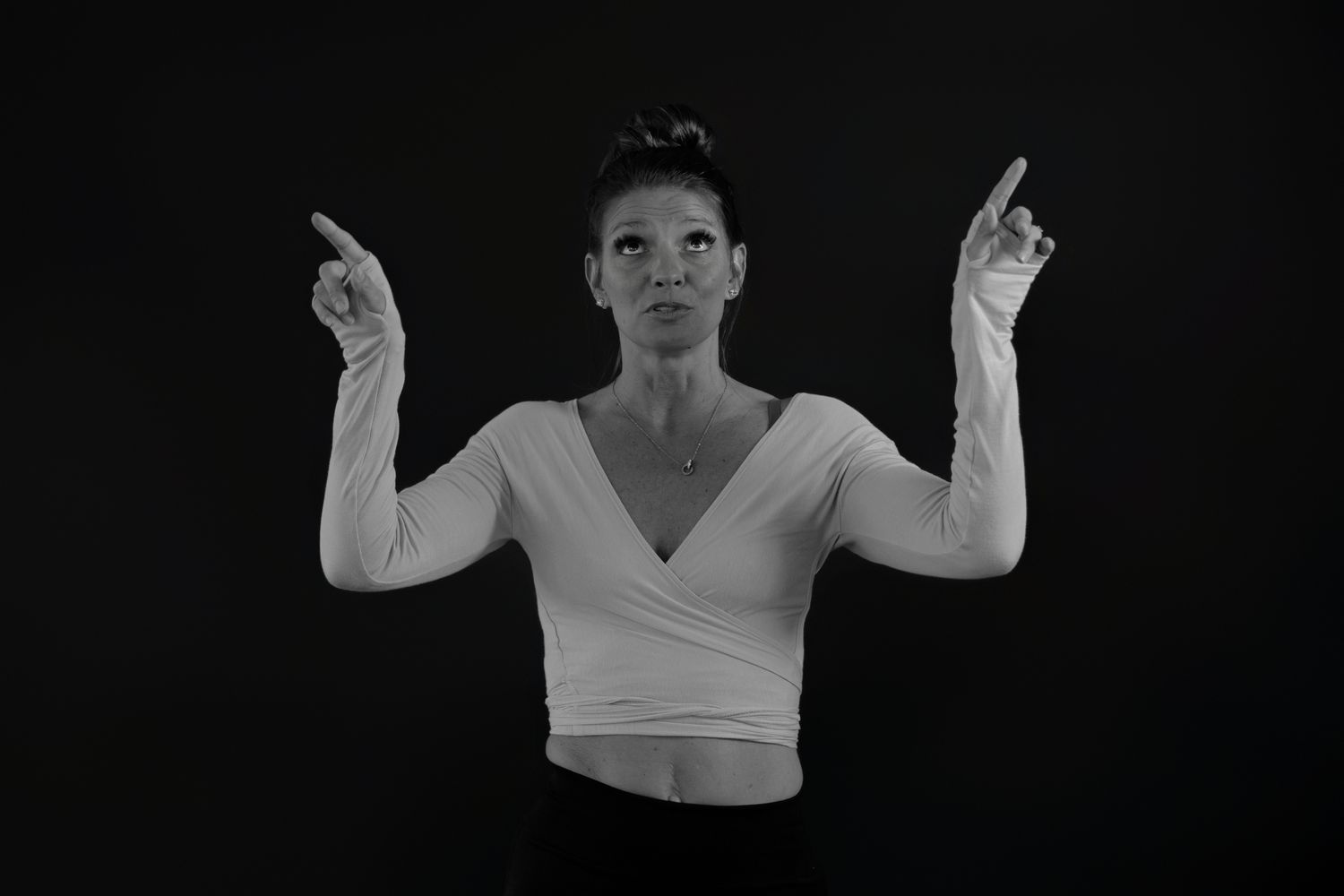 Dynamic sequence of dance movements in white top against black background.