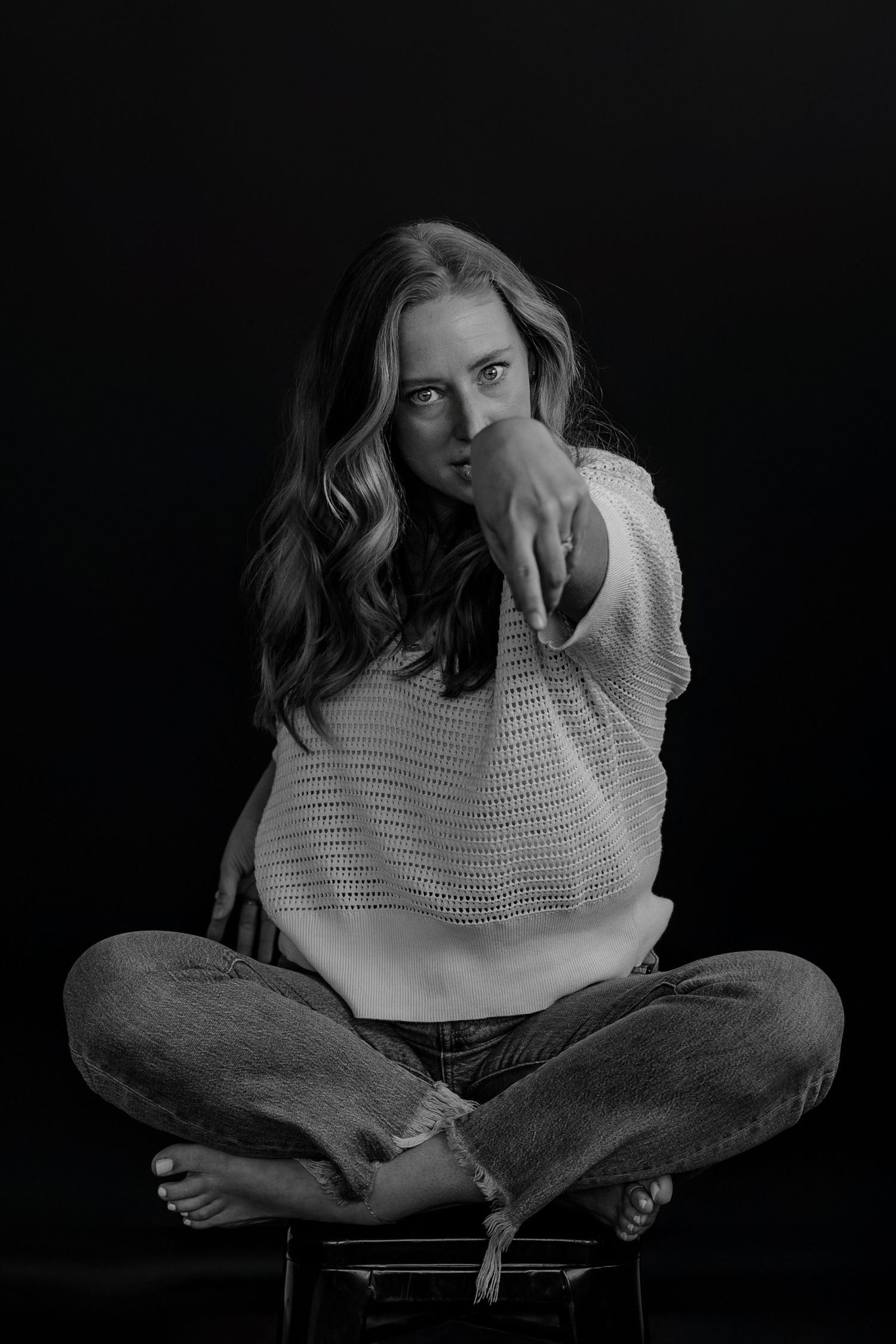Black and white portrait series showing contemplative poses in a dark studio setting.