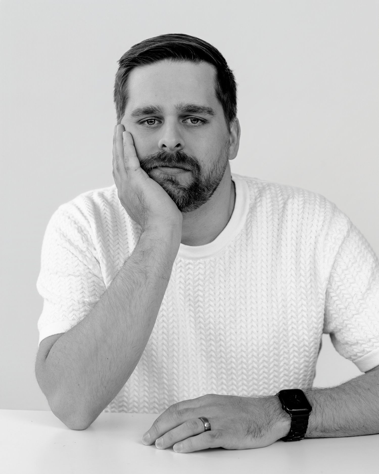 Person in white shirt showing thoughtful poses against light background.