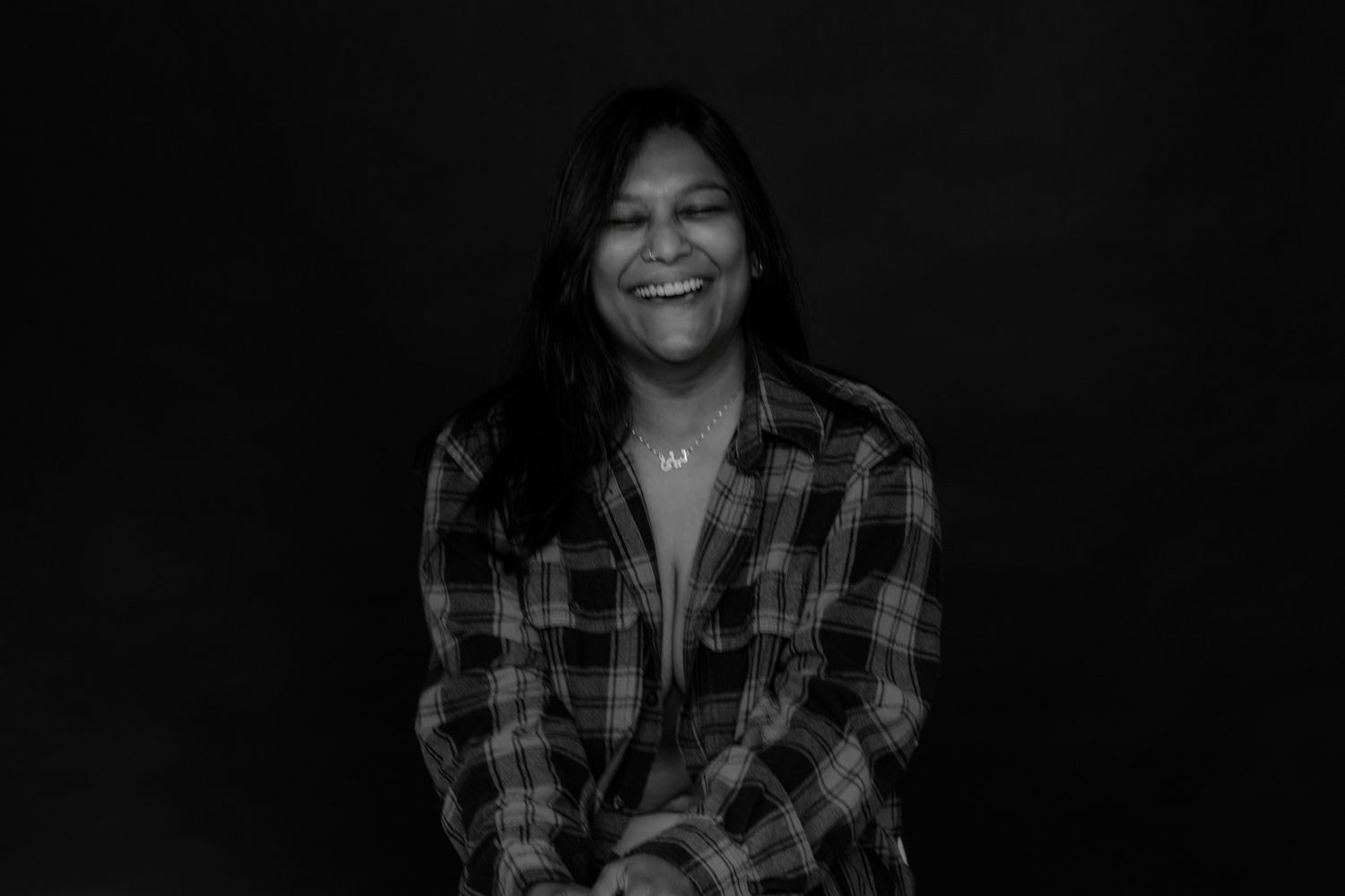 Low-key portraits showing various expressions and poses in dark setting.