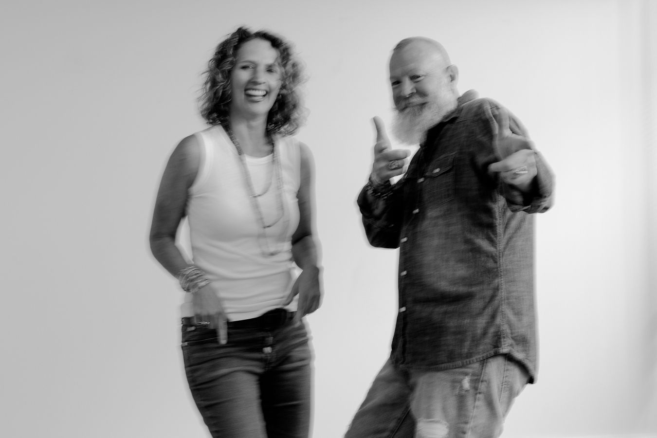 Two individuals dancing together against a white background in a candid black and white photo sequence.