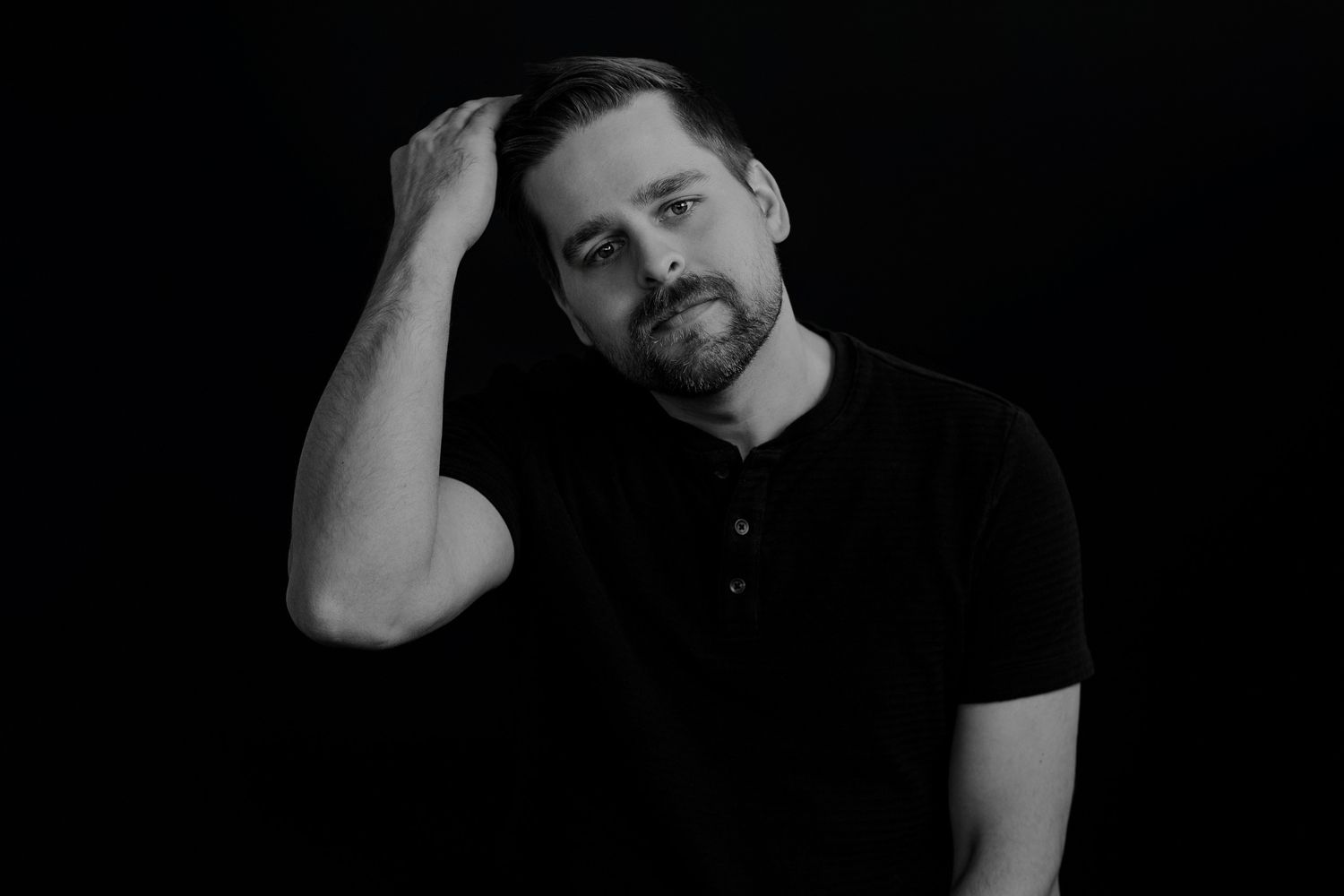 Dramatic black and white headshots sequence on dark background showing different expressions.
