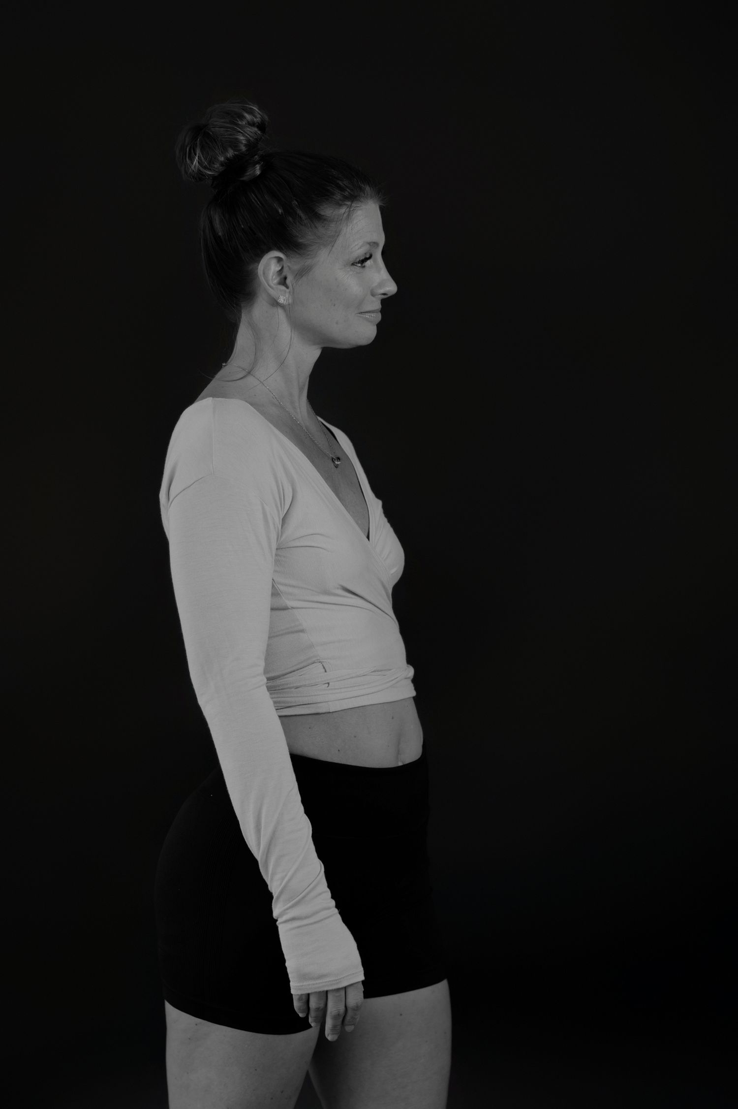 Figure in white long-sleeve top and dark bottoms shown in profile poses.