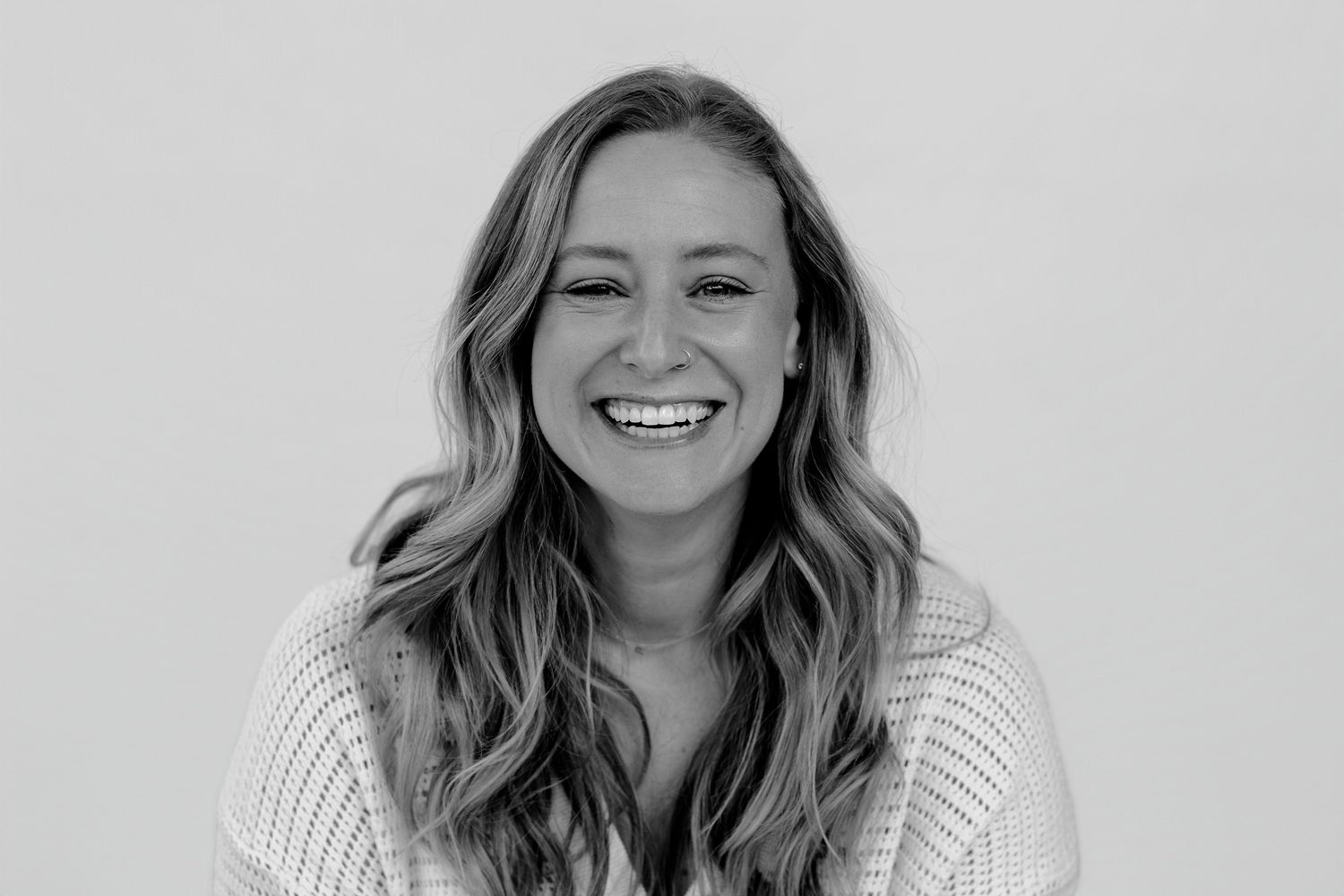 Studio portrait series showing genuine laughter and happiness against light background.