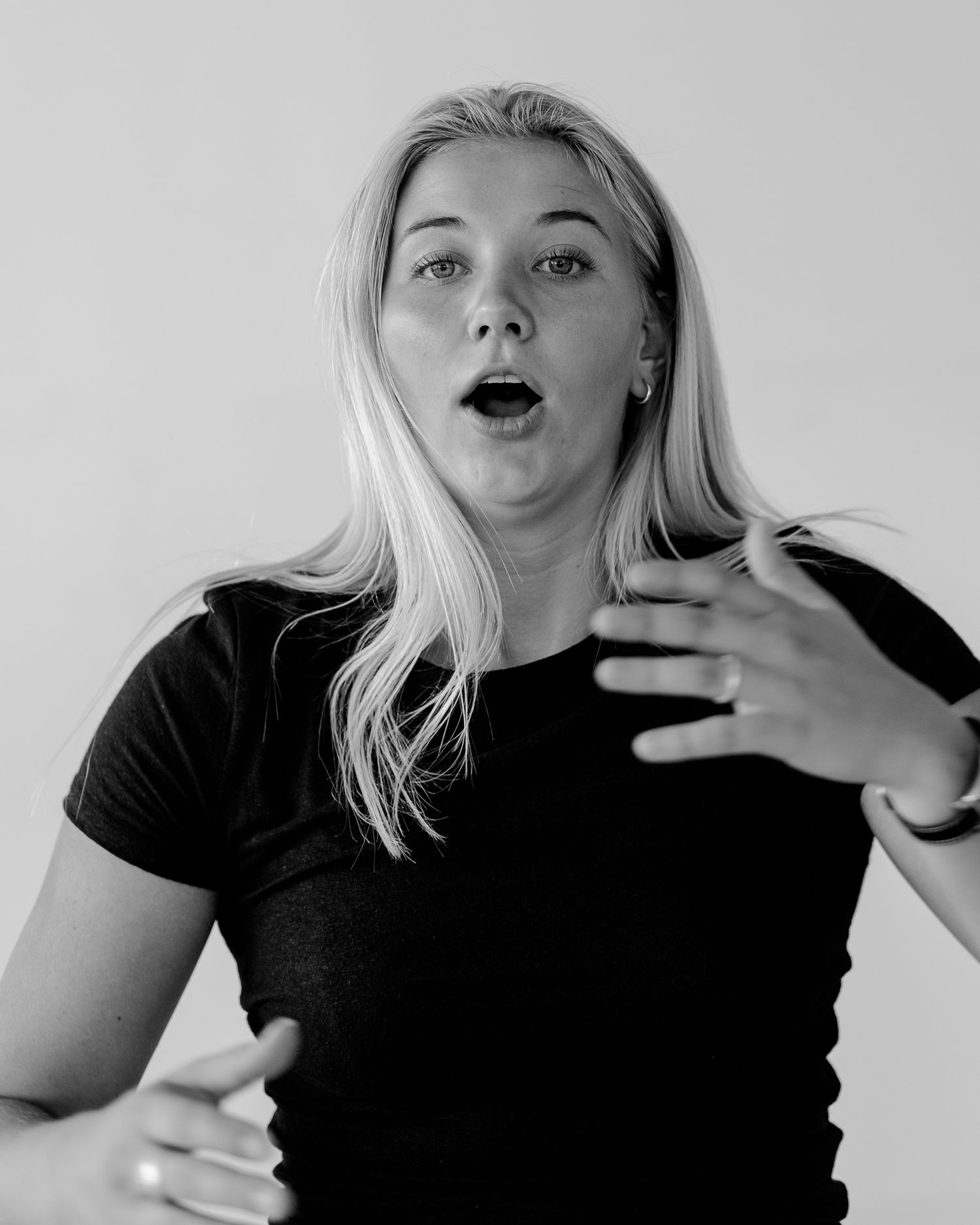 Dynamic black and white portraits capturing animated expressions and gestures.