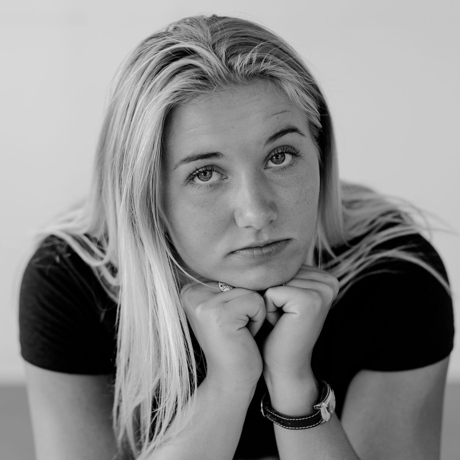 Monochrome headshot series displaying range of emotions and gestures.