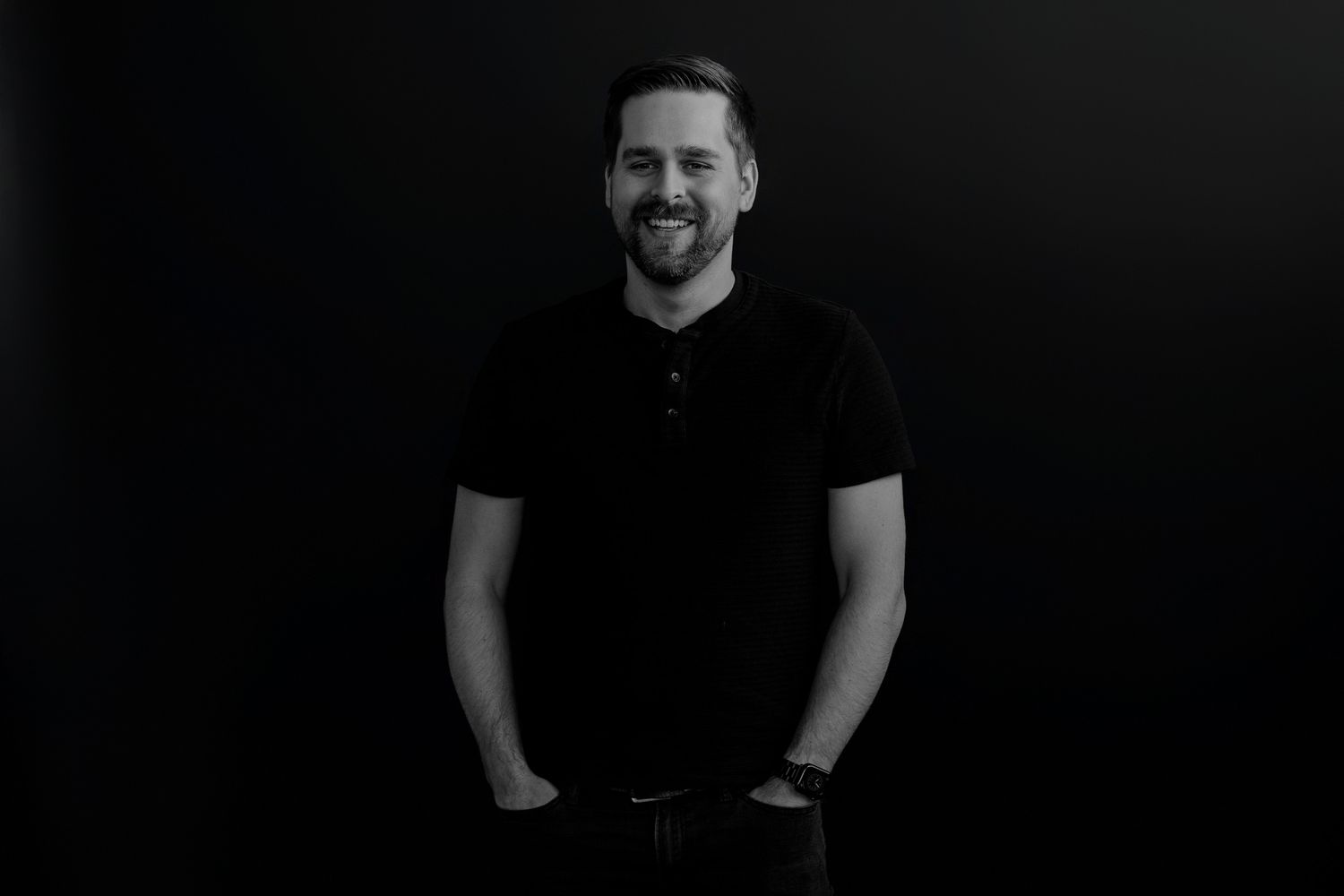 Low key studio portraits showing individuals in black attire against dark background.