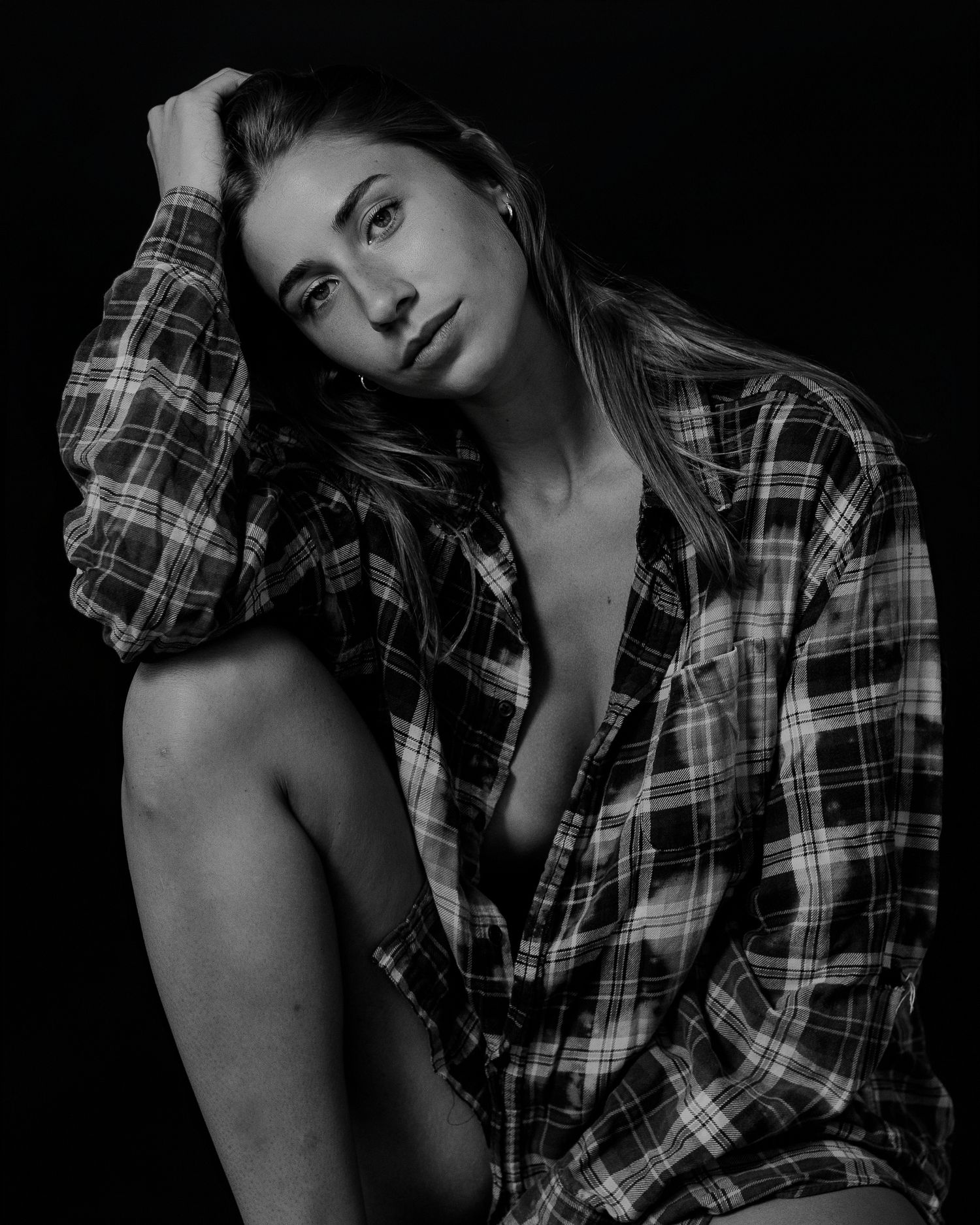 Artistic black and white fashion portraits featuring plaid shirt styling.