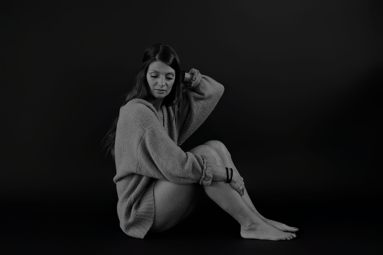 Artistic black and white photo sequence showing relaxed poses on floor.