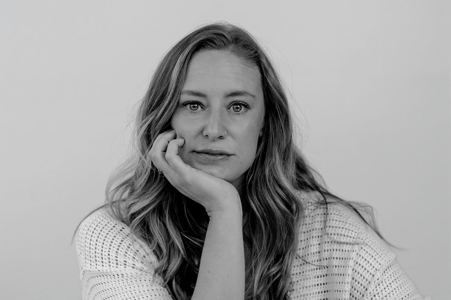 Person in white showing contemplative expressions in studio lighting.