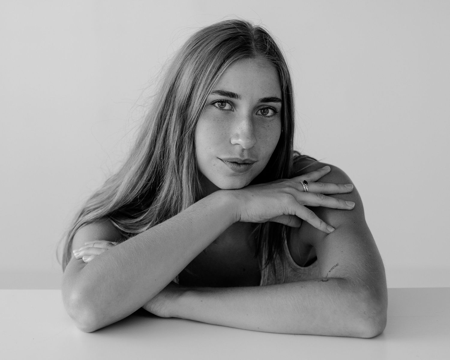 Minimal portrait series with subtle pose variations against white background.