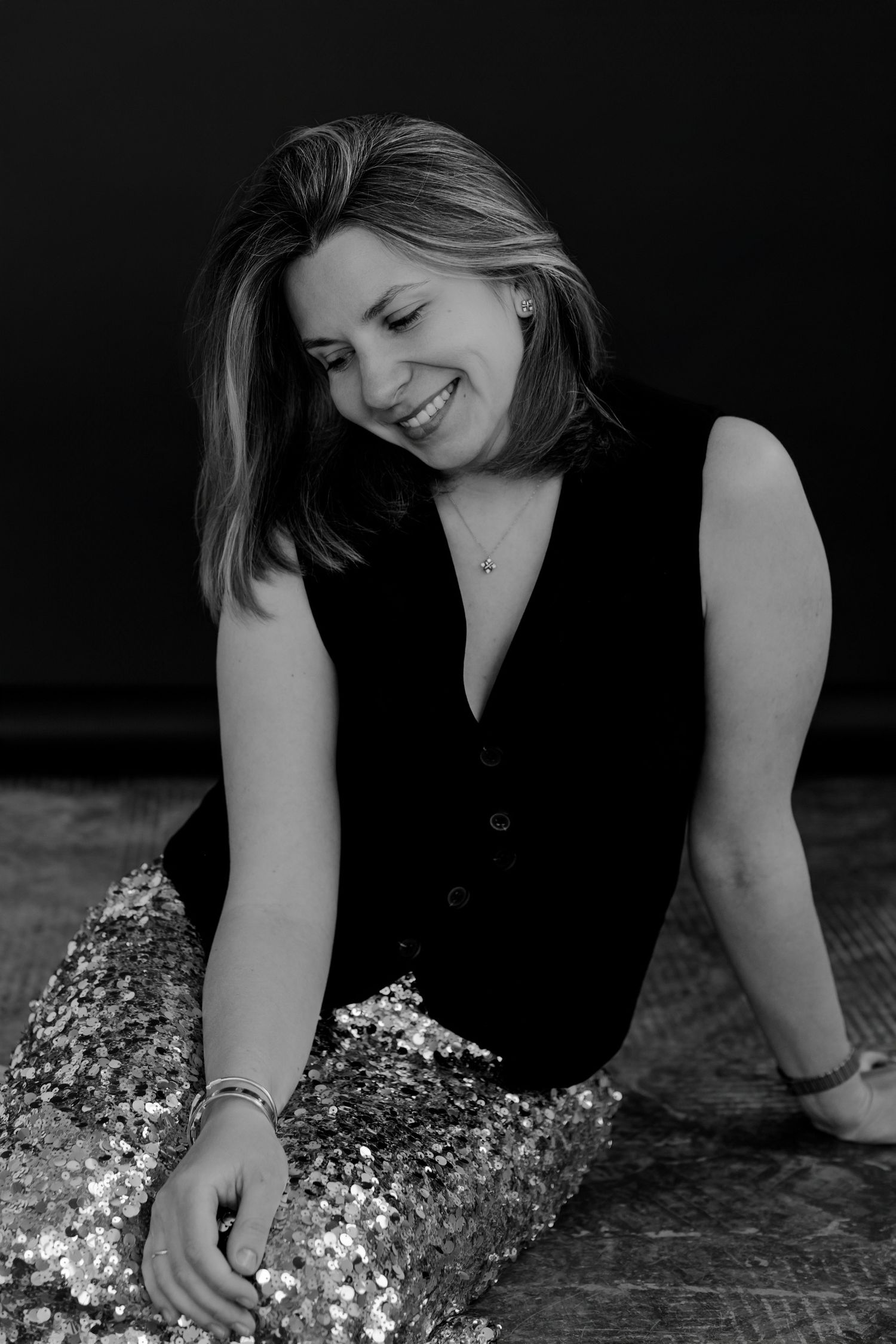 Artistic black and white photo with sparkly sequins and dramatic low angle composition.