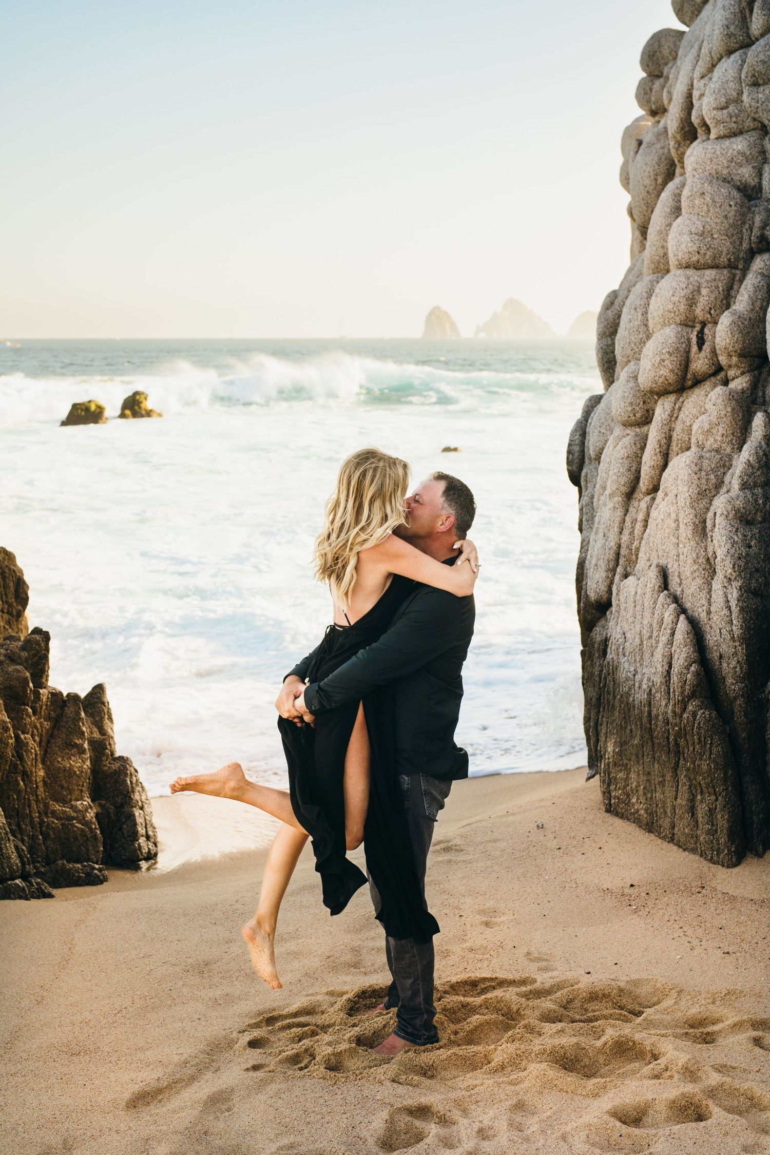 engaged couple in front of the Cabo San Lucas arch