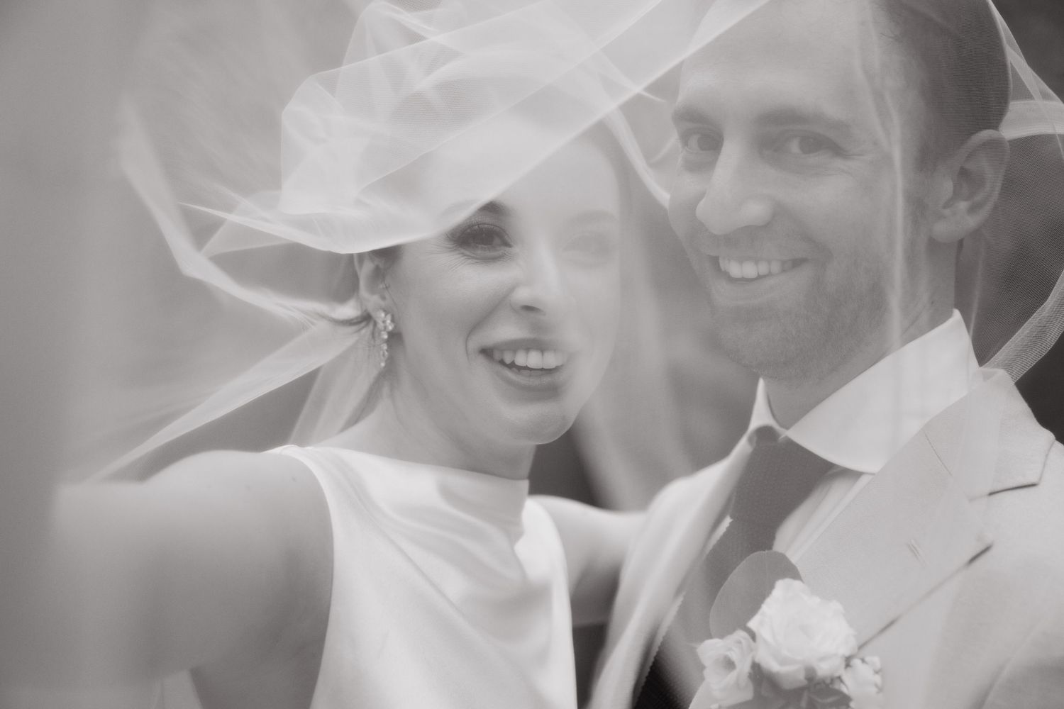 bride and groom under veil  intimate wedding in Cabo at ACRE Resort