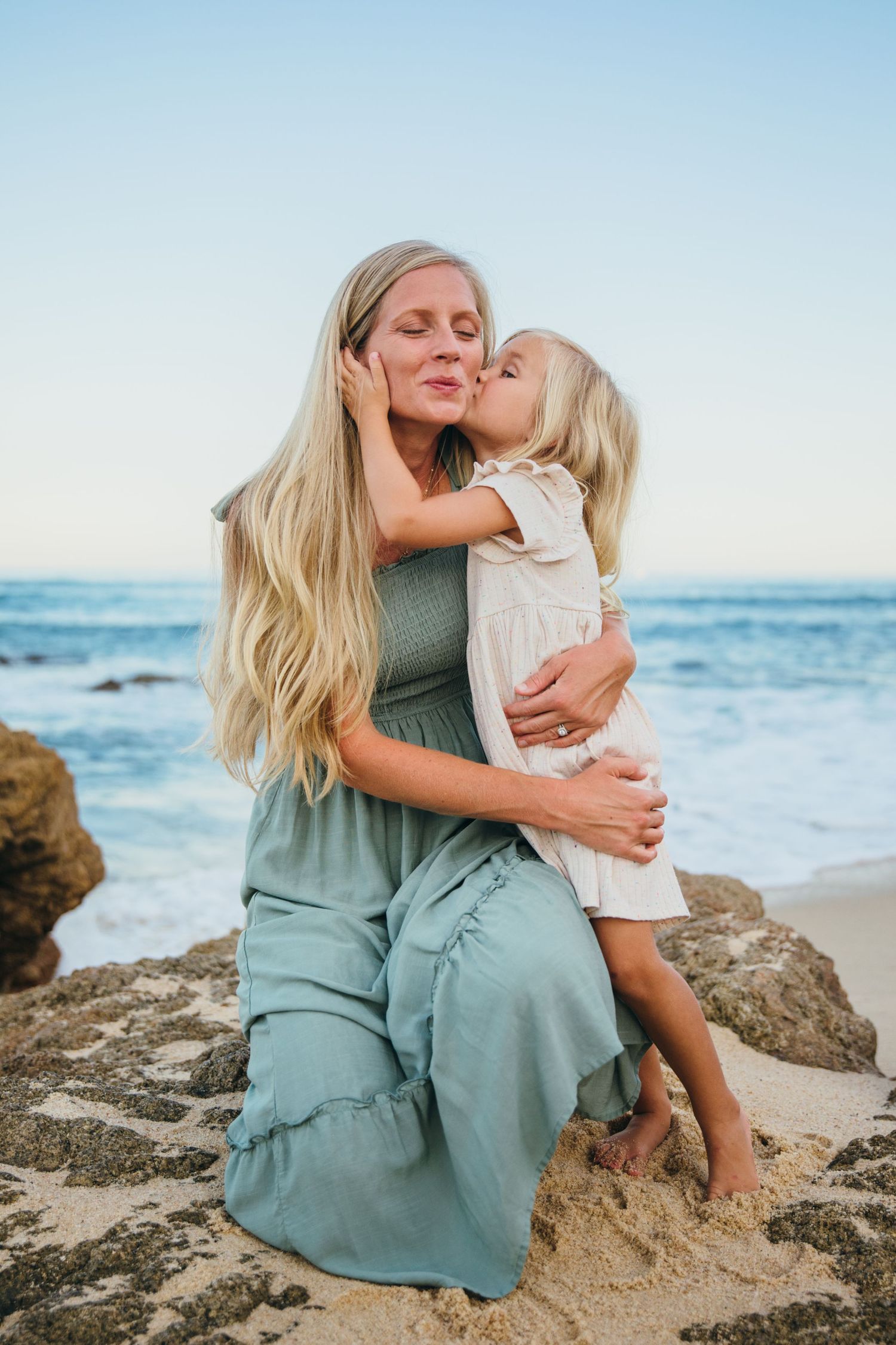 Mother and daughter playing on beach in Cabo San Lucas