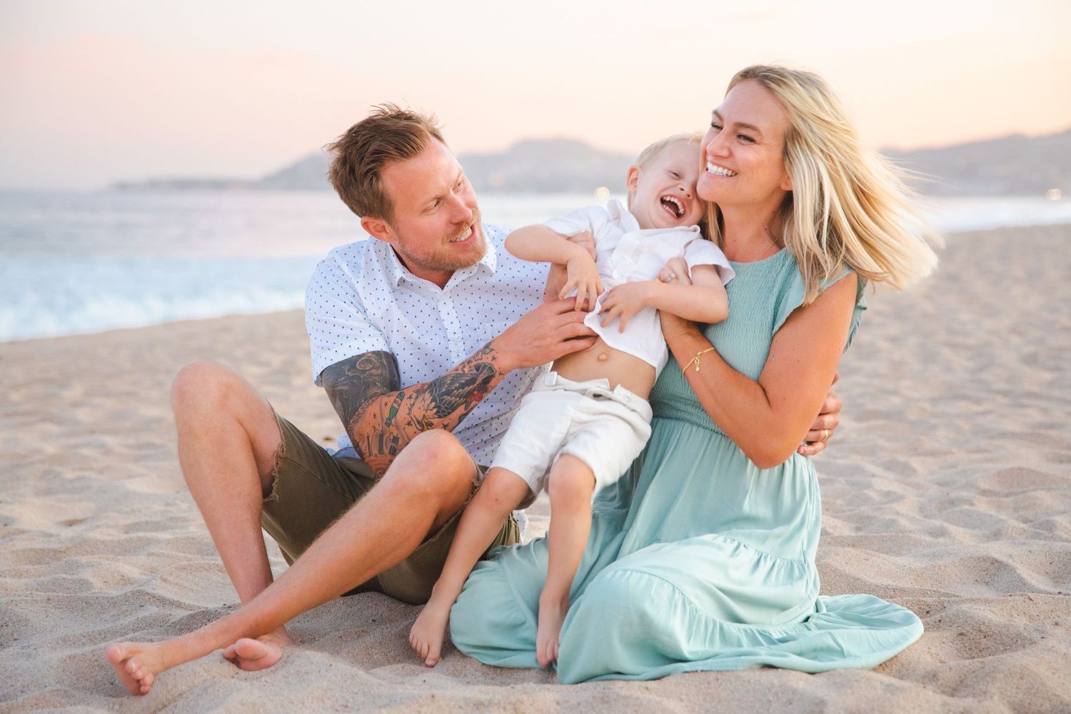 family playing on beach in Cabo San Lucas