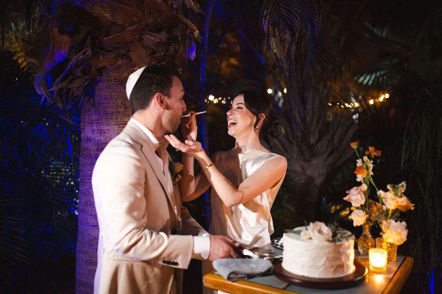bride and groom cutting cake in Cabo at intimate wedding at ACRE Resort