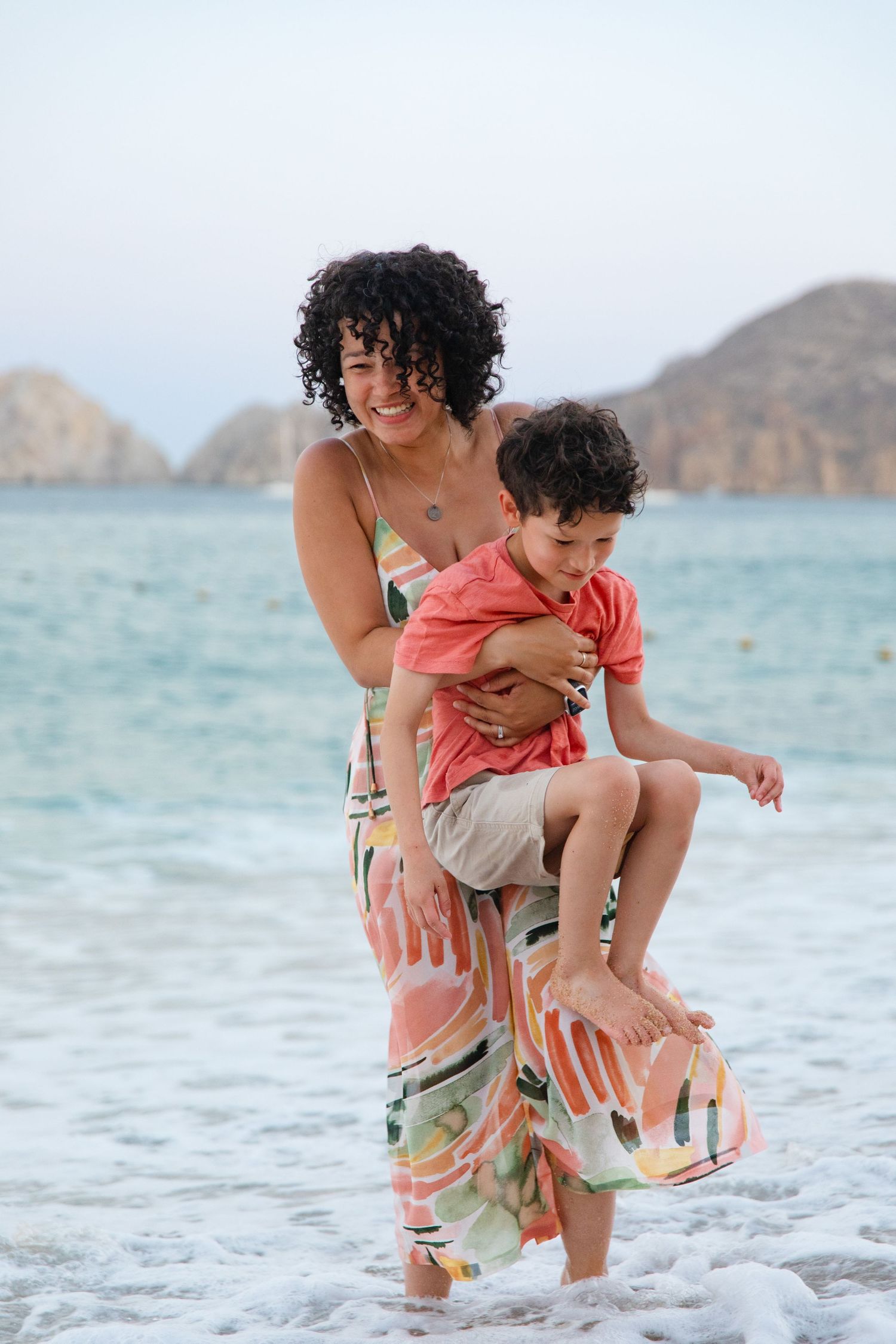 mother and son playing on beach in Cabo San Lucas
