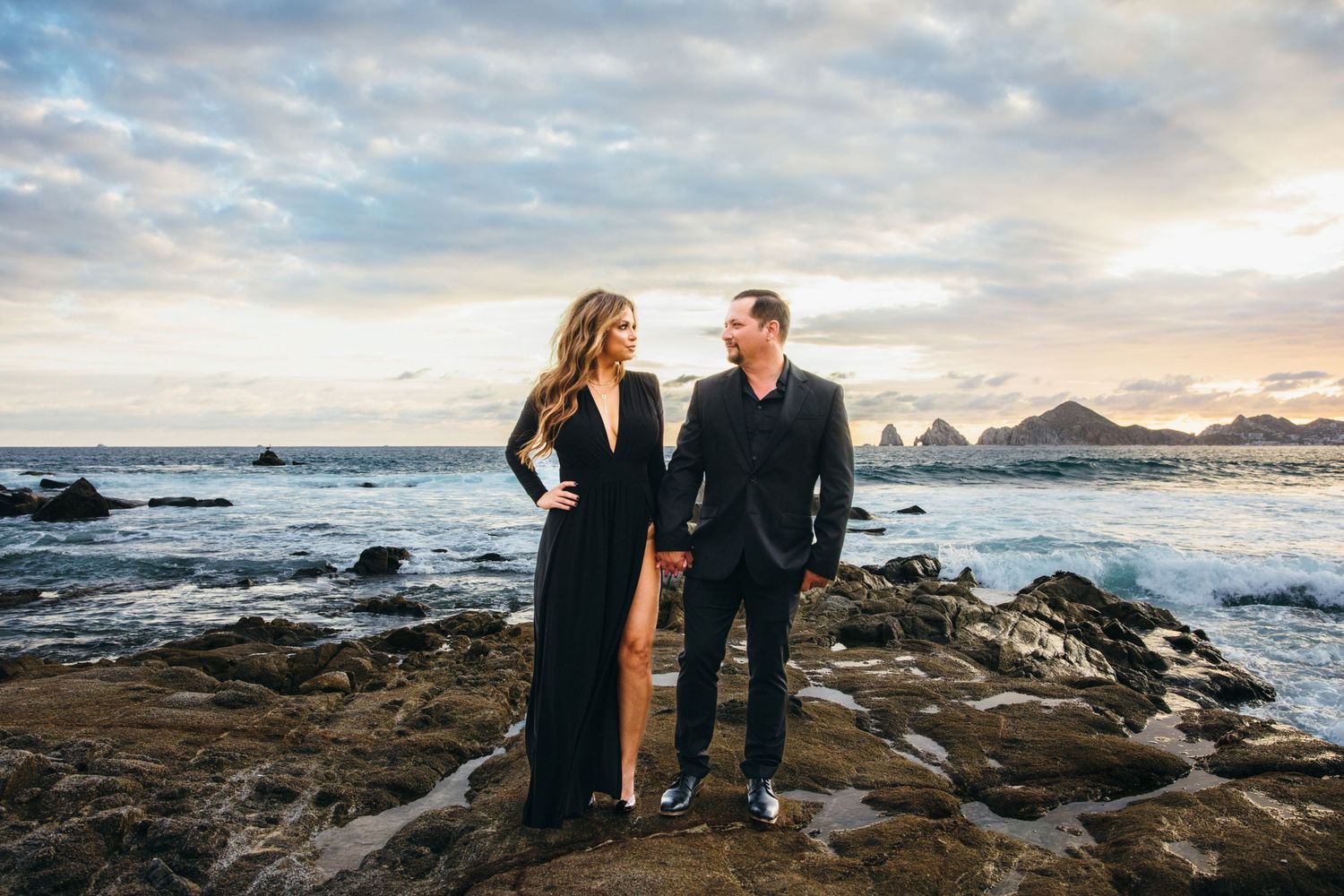 engaged couple in front of the Cabo San Lucas arch