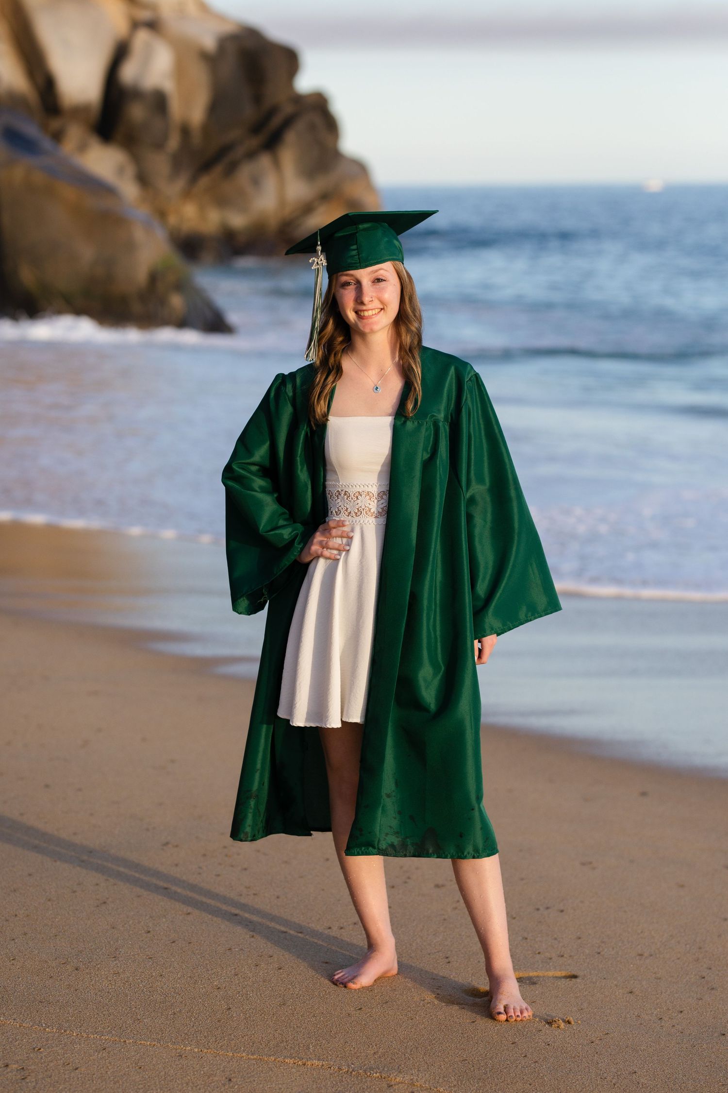 girl in cap and gown on beach in Cabo San Lucas