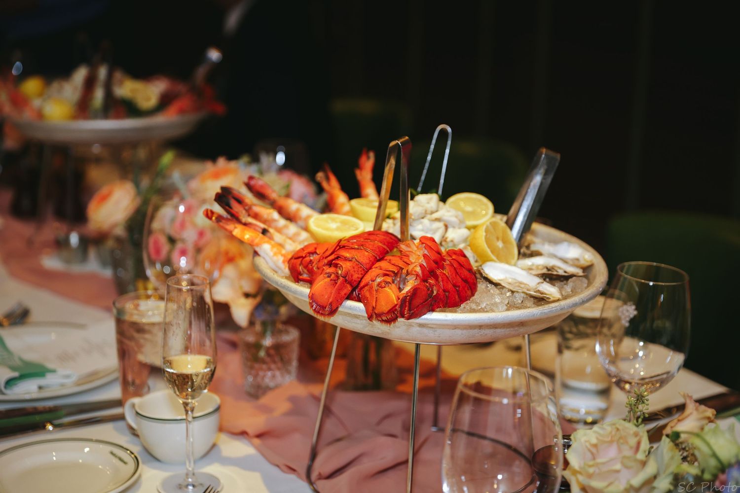 Elegant seafood platter with lobster tails and cocktail shrimp displayed on a banquet table.
