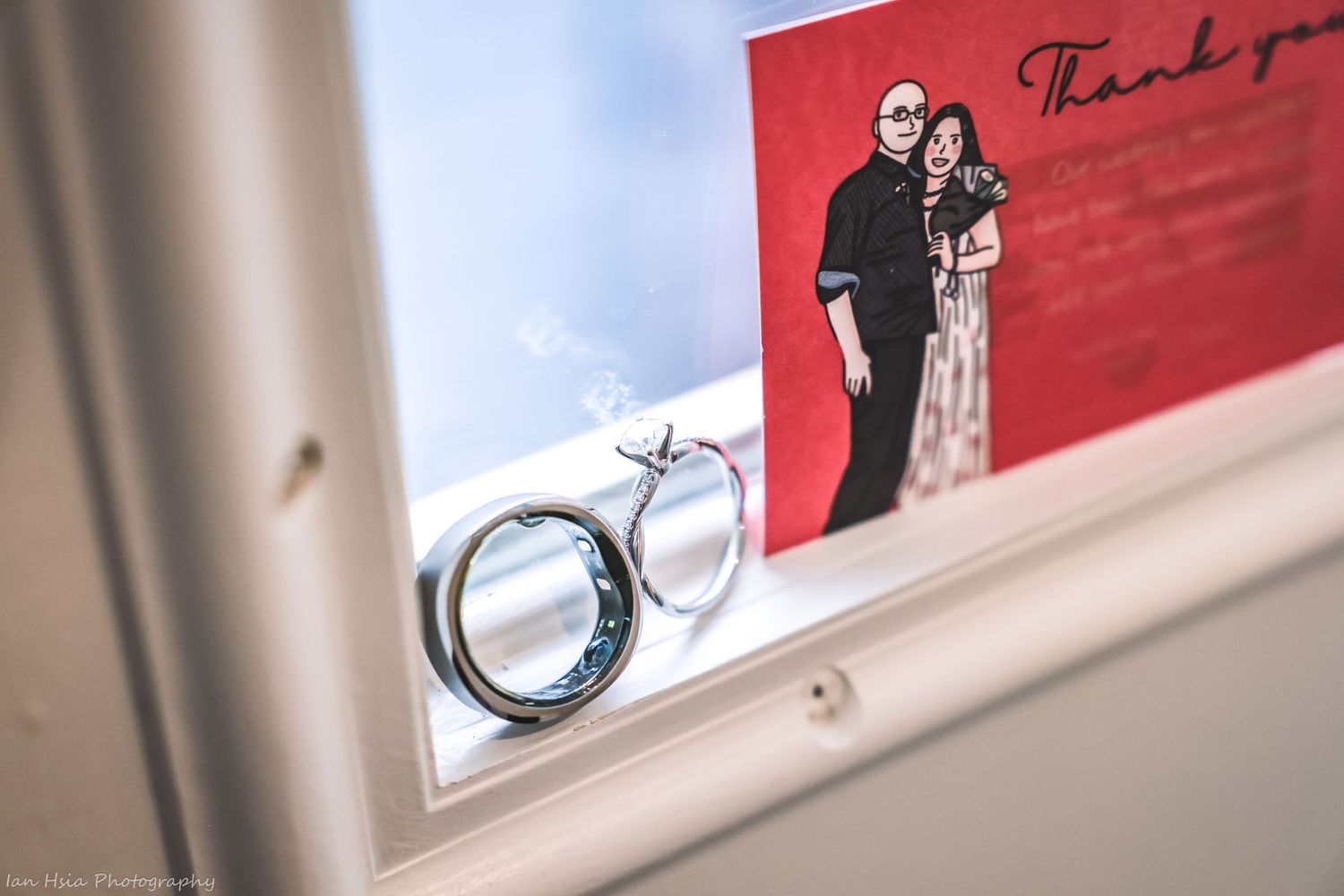 Wedding rings and engagement jewelry displayed in a professional photography setup.