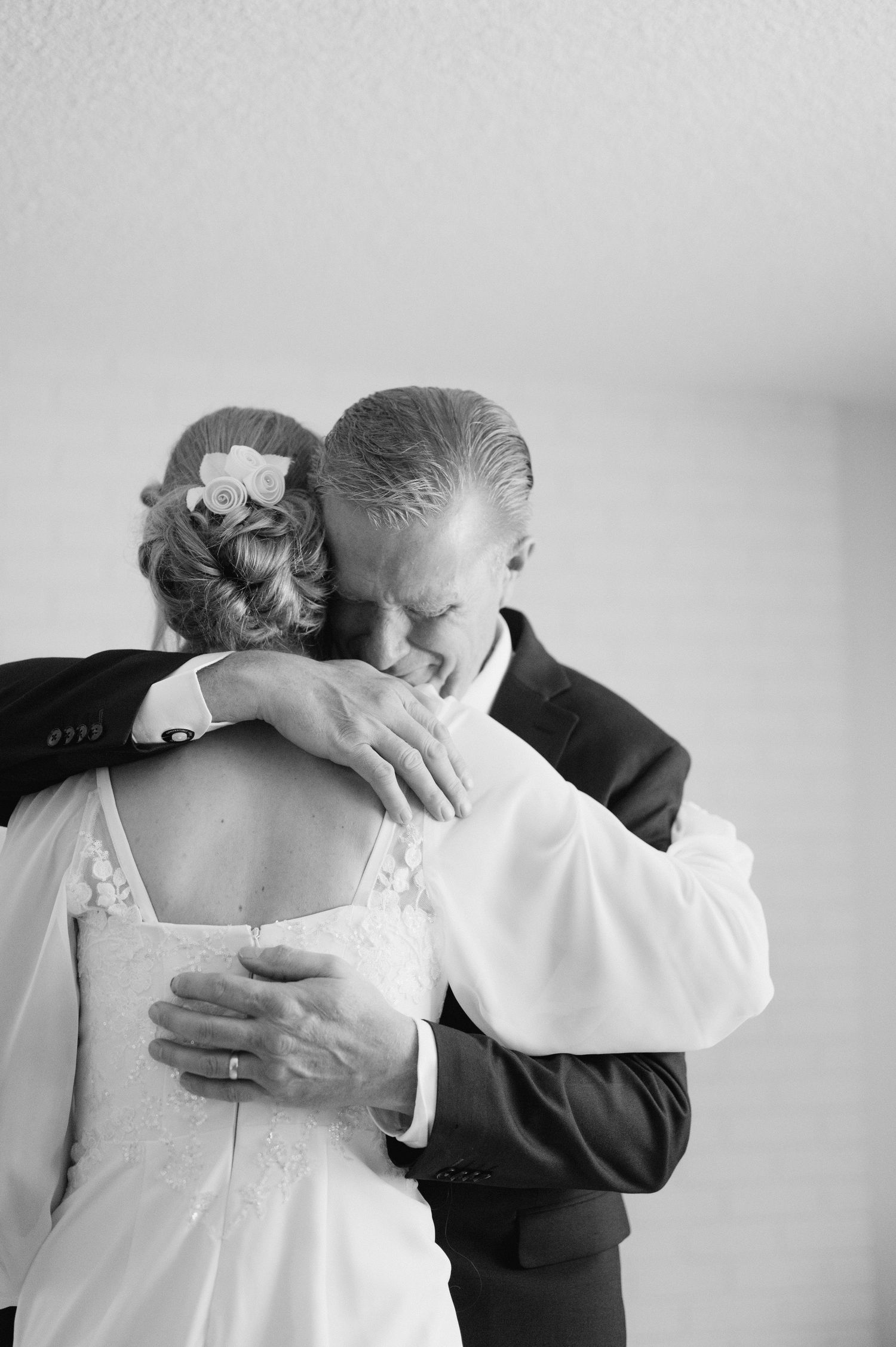 Black and white photo series showing an intimate embrace between two people in formal attire.