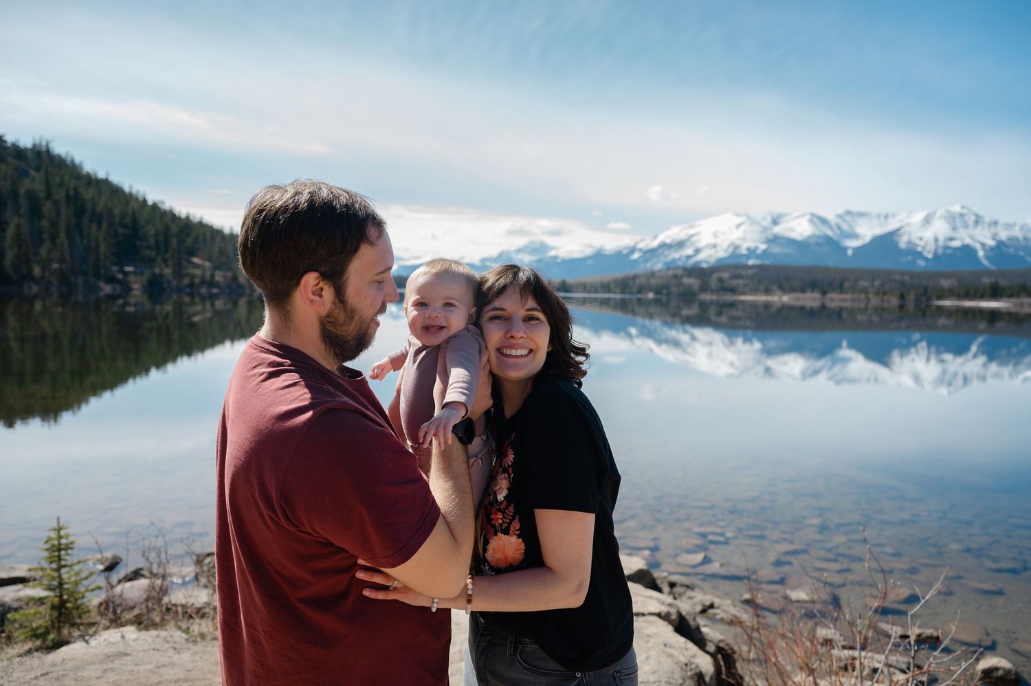 A romantic engagement photo series captured against a backdrop of mountains and lake.